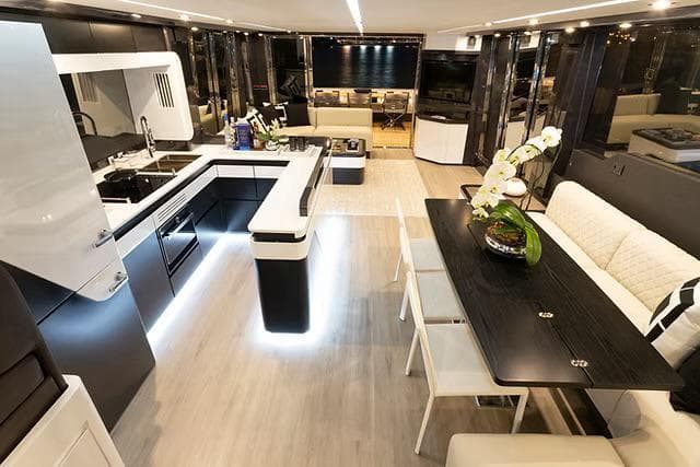 Luxurious interior of 2026 Schaefer 770 yacht with modern kitchen and elegant dining area.