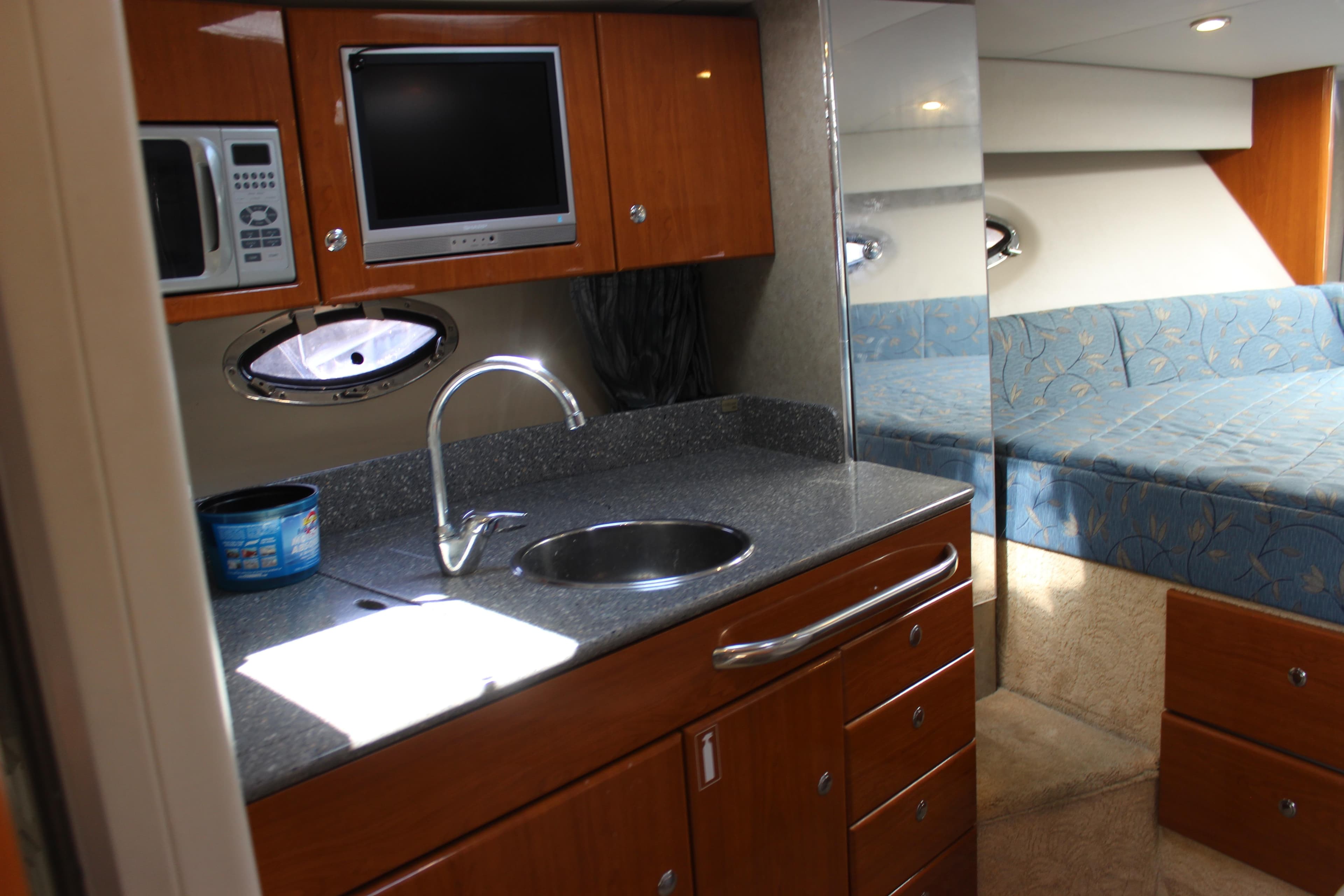 2005 Formula 31 Performance Cruiser interior with kitchenette and cozy seating area.