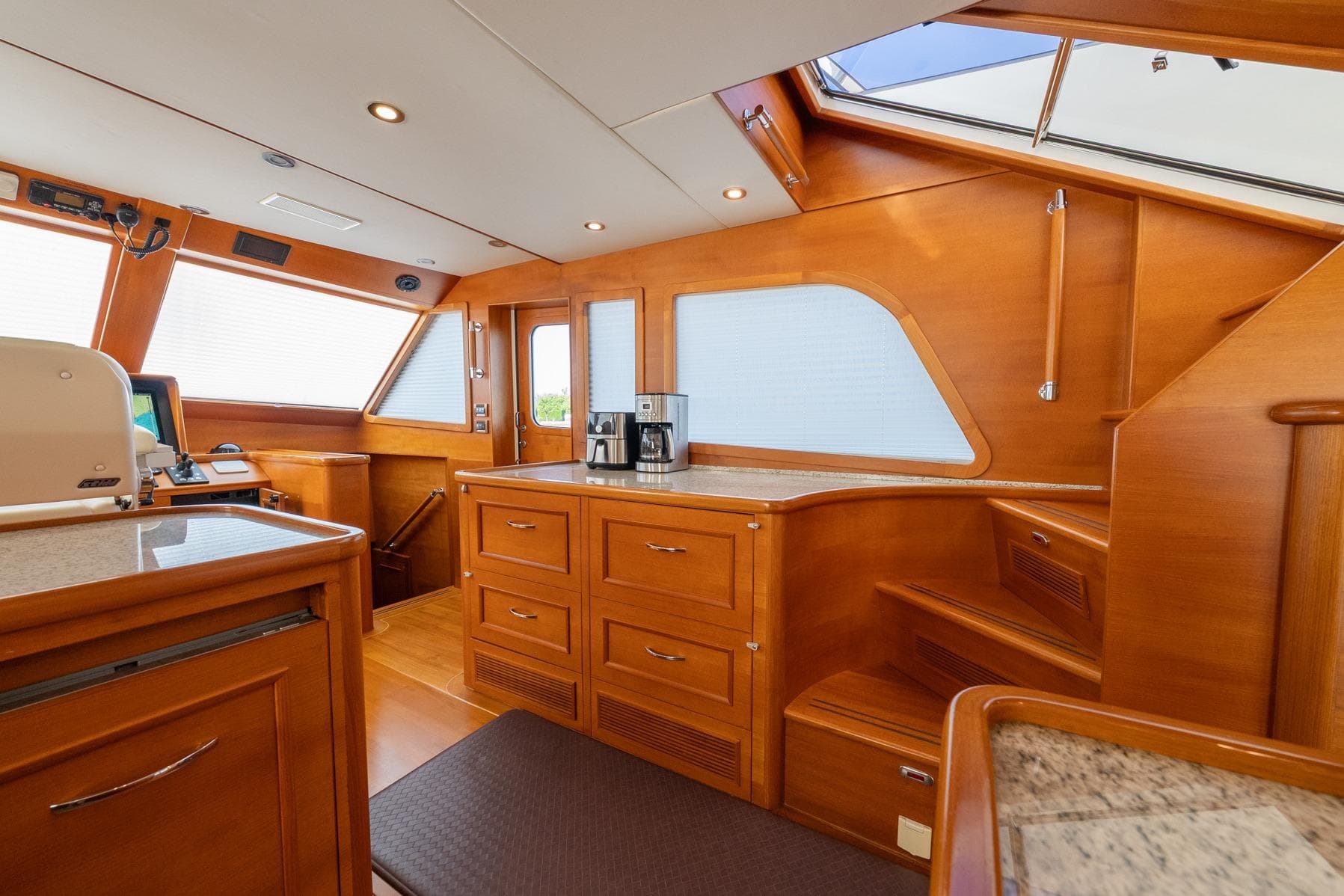 Luxurious interior of 2016 Grand Banks 72 Aleutian RP yacht with wooden cabinetry and modern amenities.