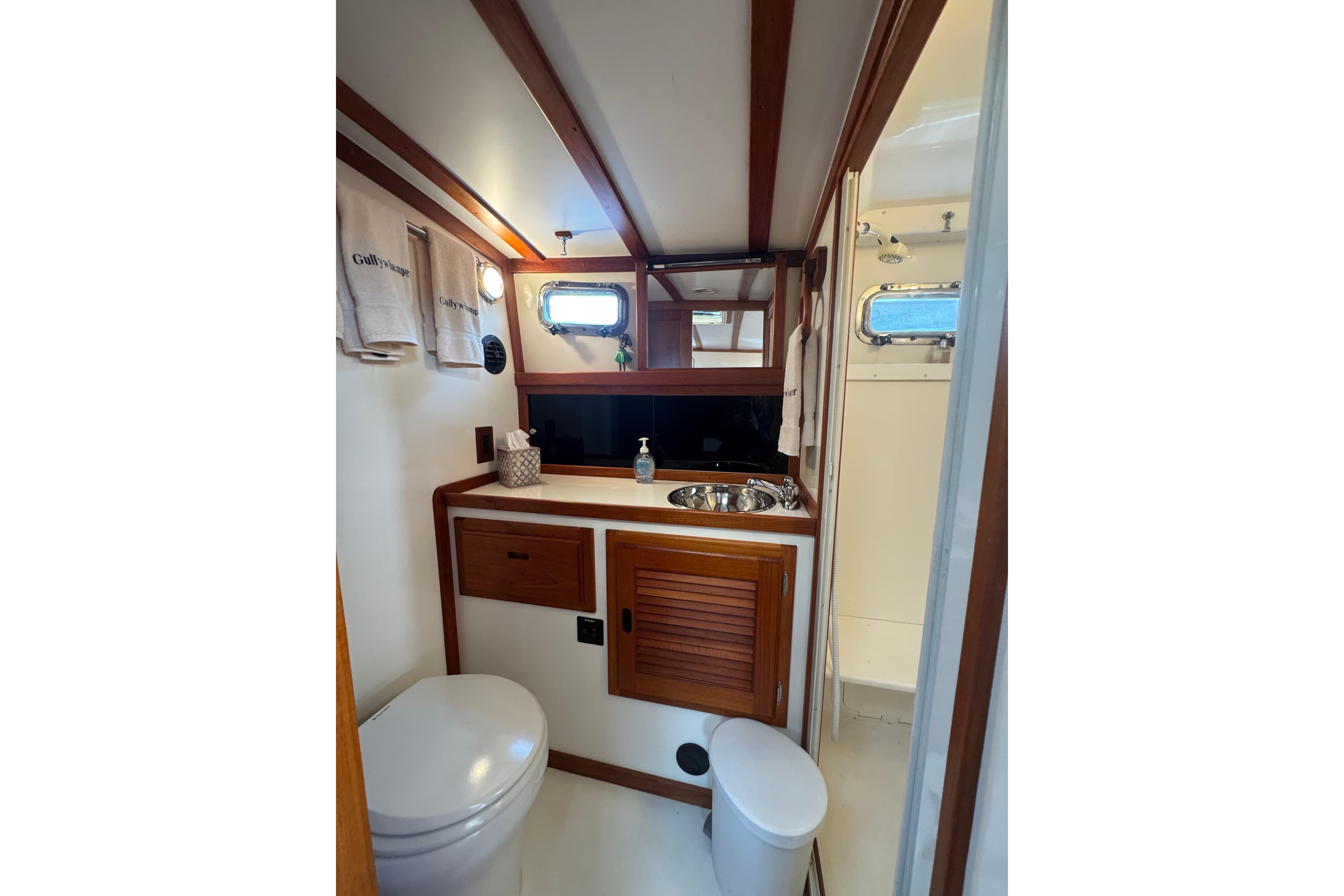 2001 Ellis 36 Flybridge bathroom with wooden accents and compact design.