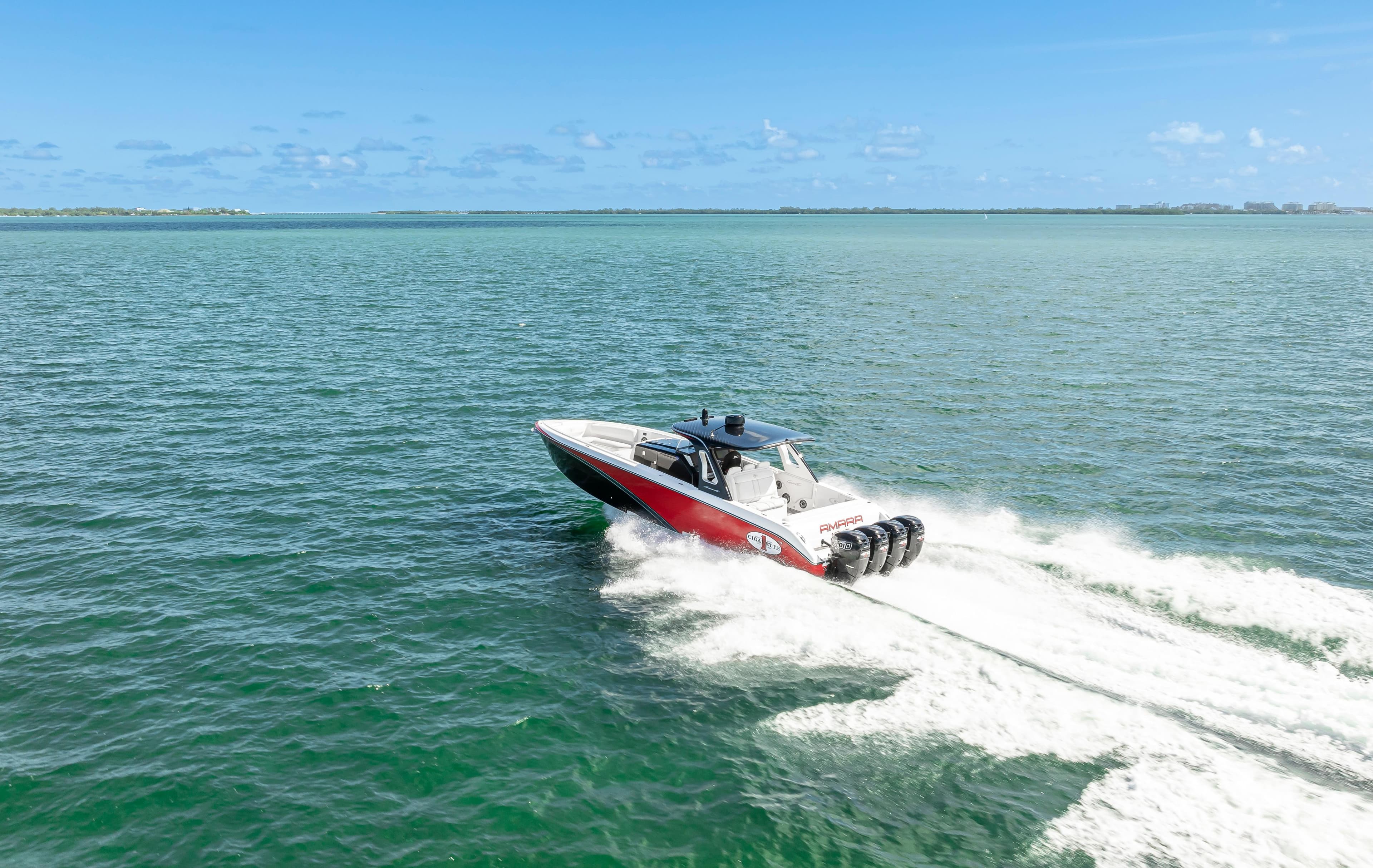 2016 Cigarette 41 GTR speedboat cruising on open water under clear blue skies.