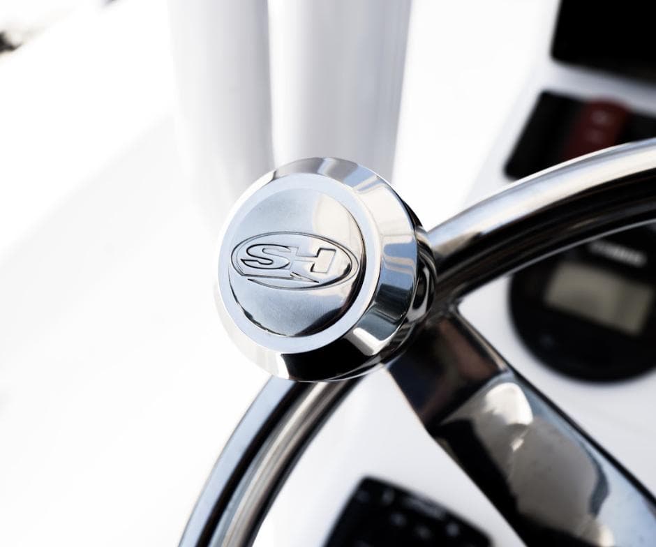 Close-up of 2025 Sea Hunt Ultra 219 steering wheel with SH logo.