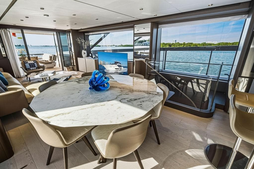 Luxurious interior of 2023 Ferretti Yachts 860 with elegant dining area and scenic ocean views.