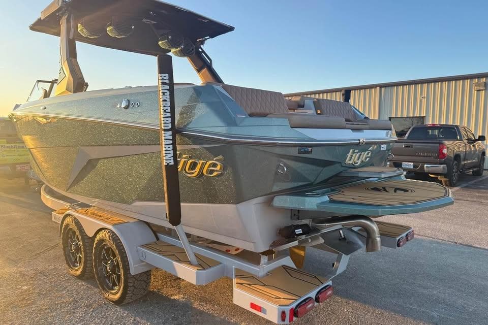 2026 Tigé Z3 boat on trailer at sunset, showcasing sleek design and modern features.