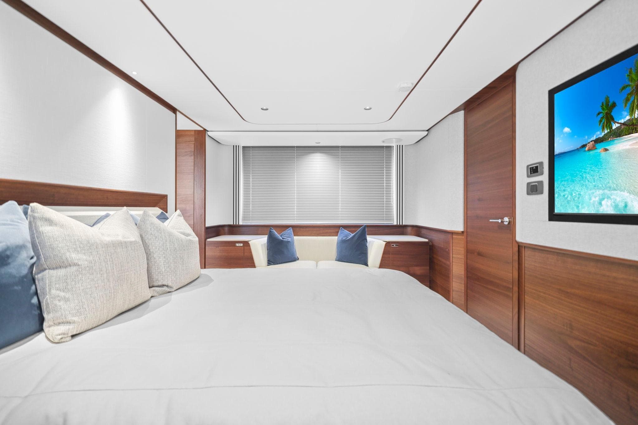 Luxurious bedroom interior of 2026 Princess F65 yacht with modern decor and ocean view.