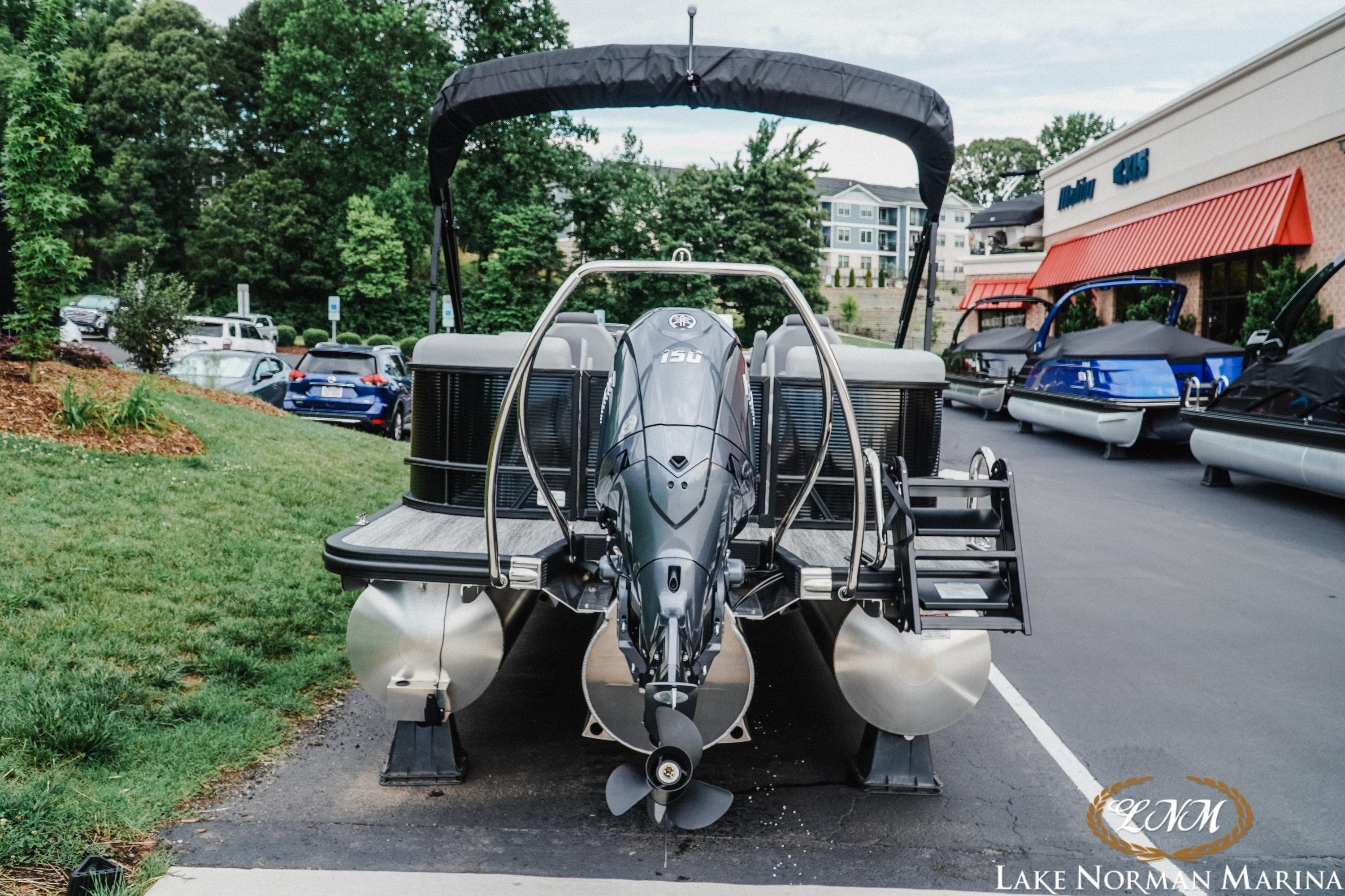 2026 Bennington 22SSR pontoon boat at Lake Norman Marina, featuring a powerful outboard motor.