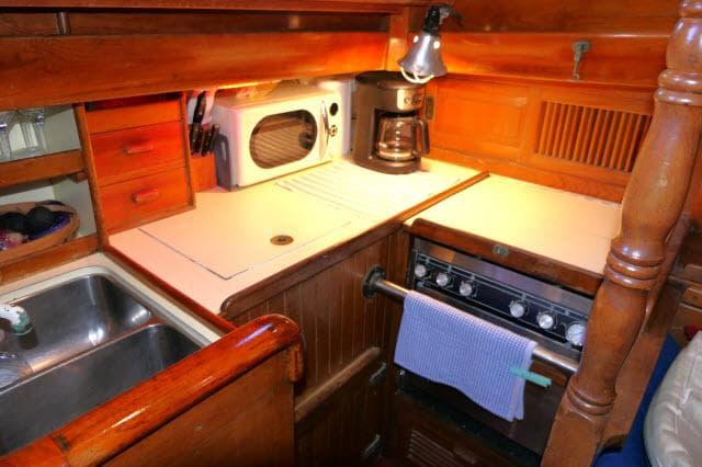 1978 Brewer 45 Ketch galley with stove, microwave, and coffee maker.
