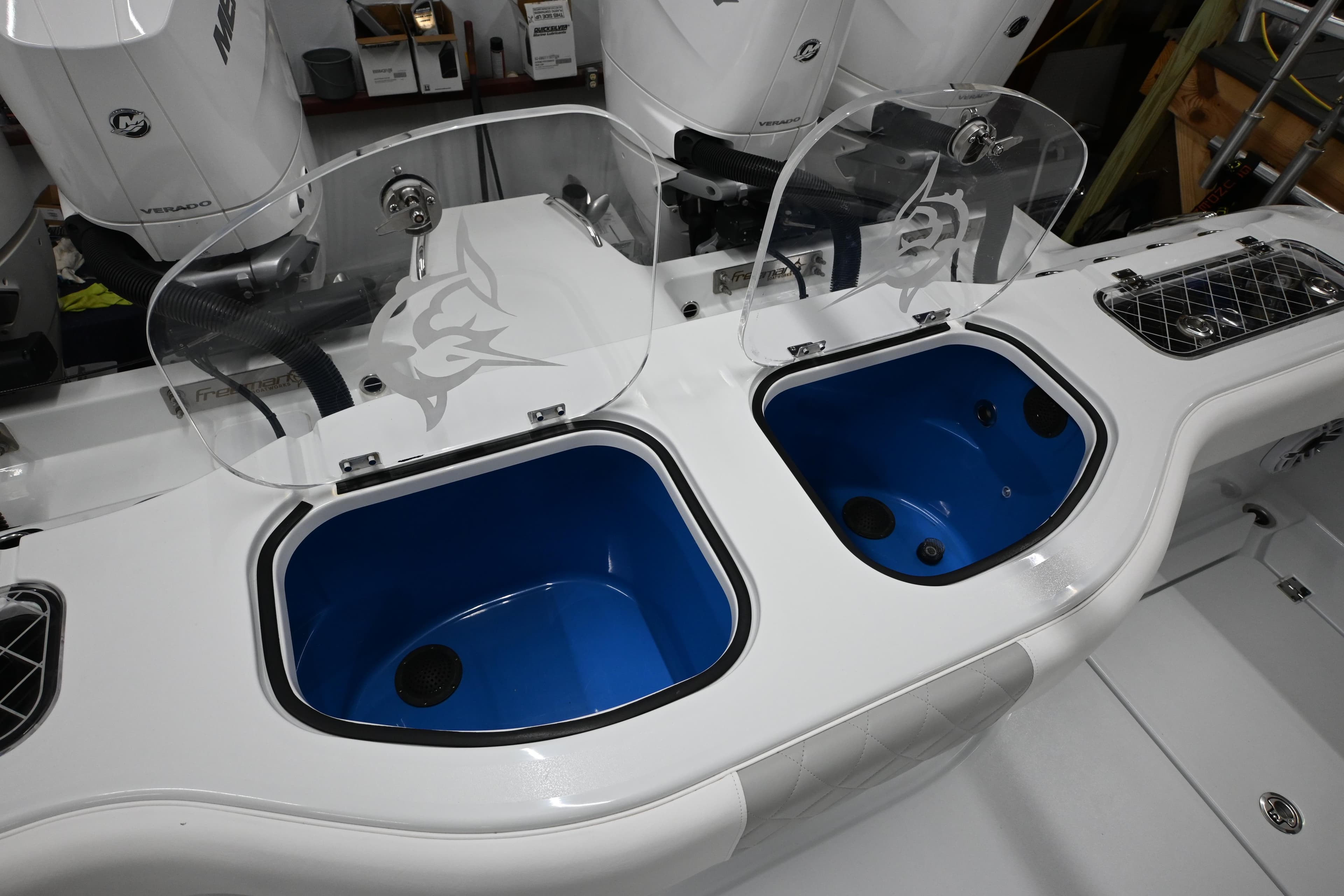 2024 Freeman 43 boat with dual livewells and transparent lids, featuring a sleek design.
