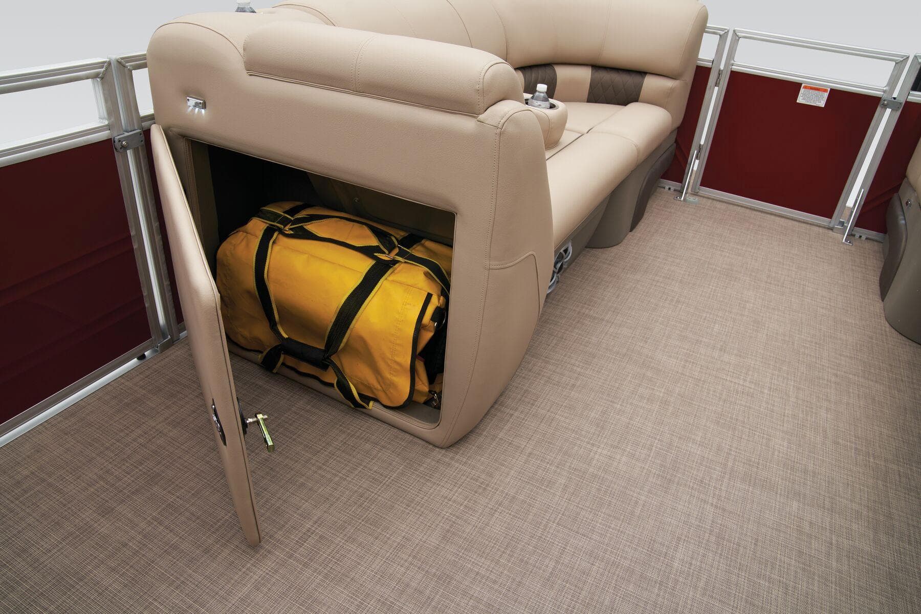 Sun Tracker Party Barge 20 DLX 2024 interior storage compartment with yellow duffel bag.