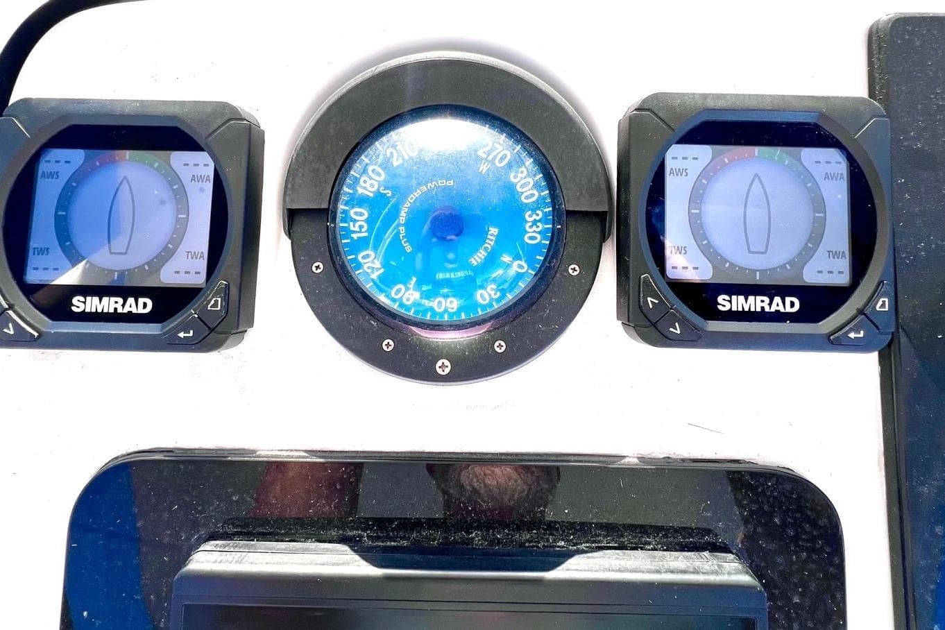 Boat dashboard with Simrad instruments and compass on a 2002 Intrepid 366.