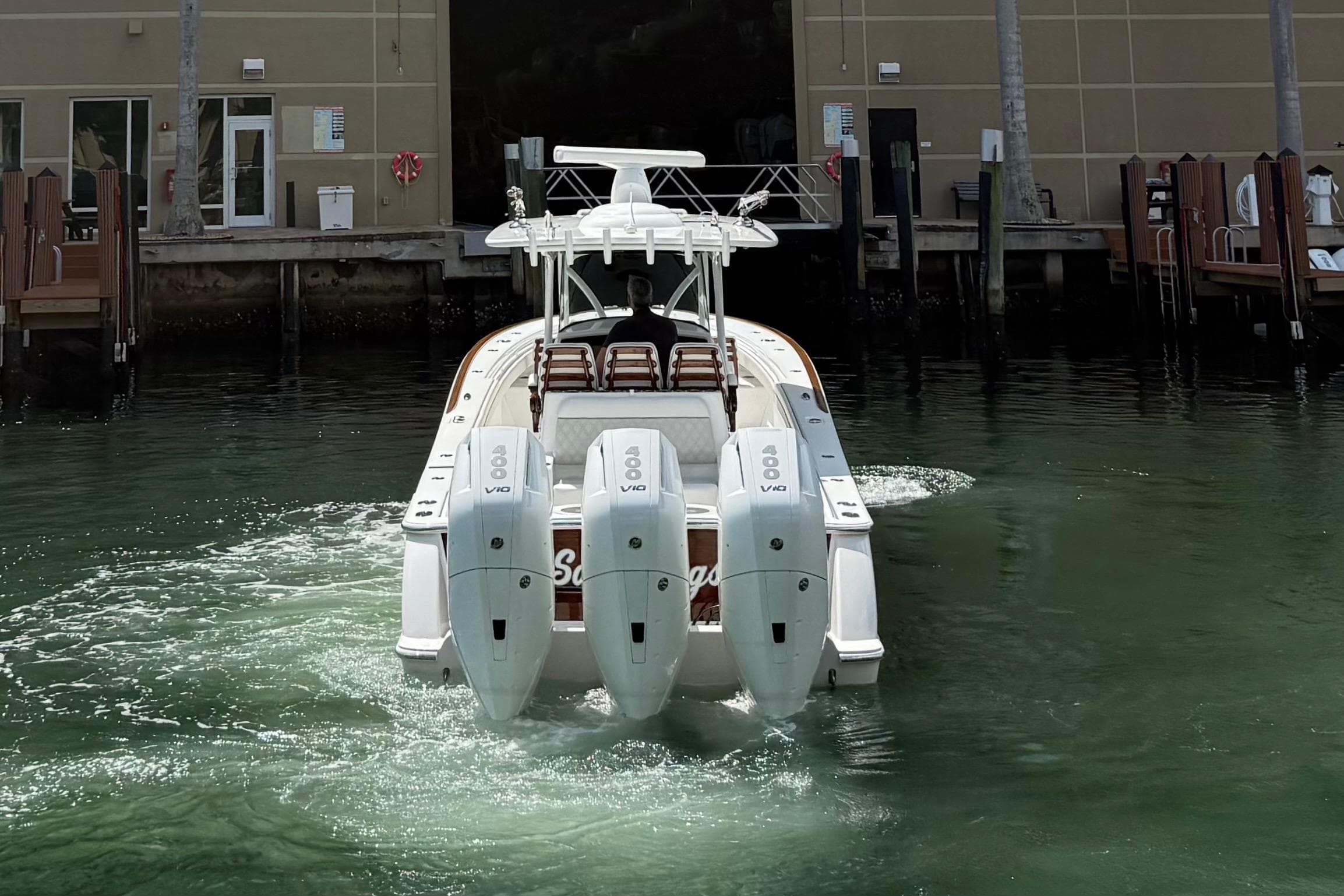 2024 Valhalla Boatworks V-37 with triple engines, docked in a marina.