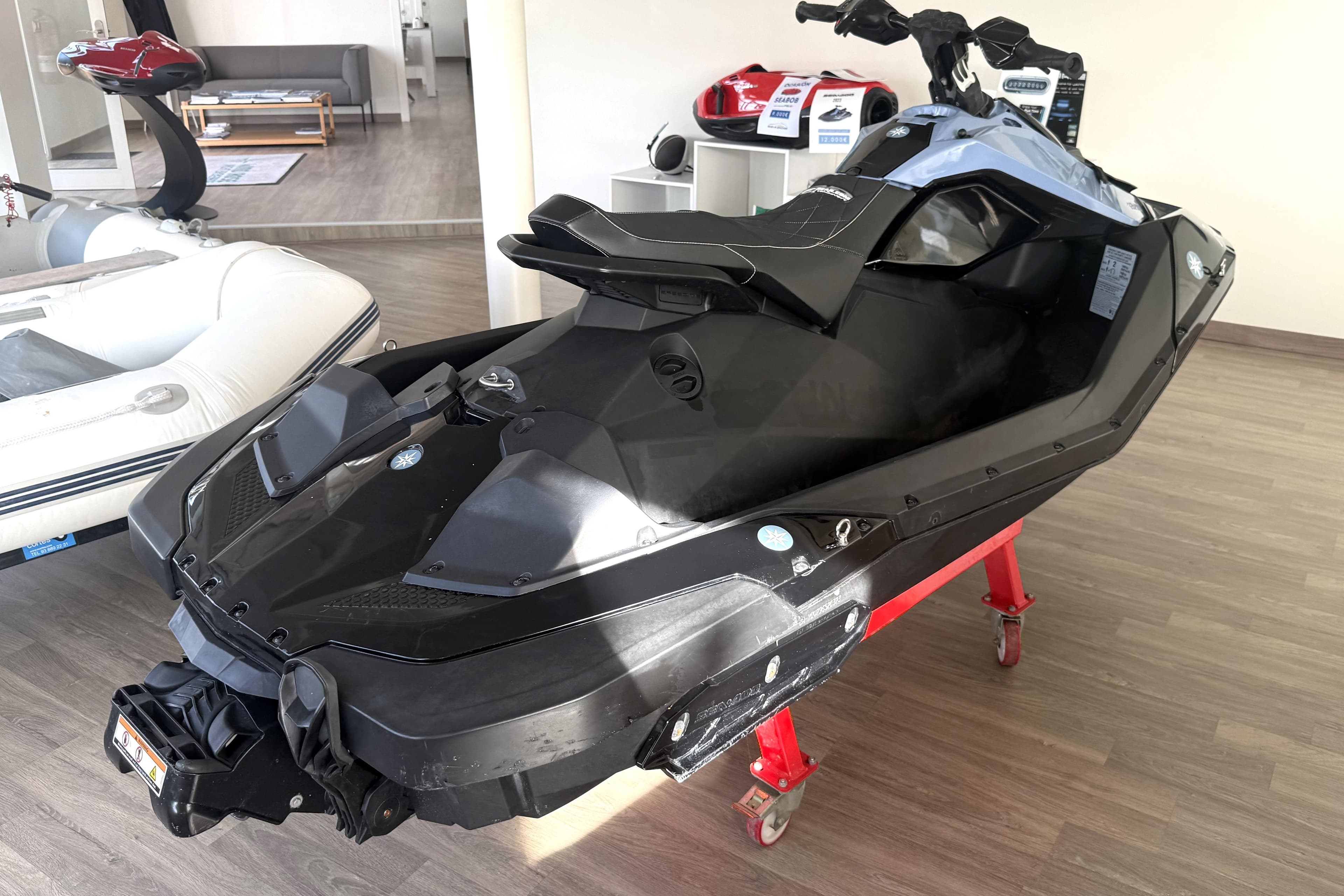 2023 Sea-Doo Spark Trixx 2up jet ski displayed indoors on a stand.