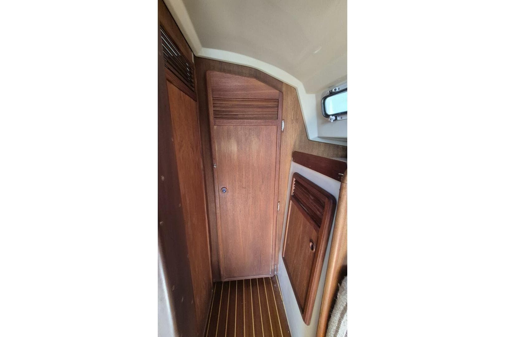 1984 Mirage Yachts 35 interior with wooden door and paneling.