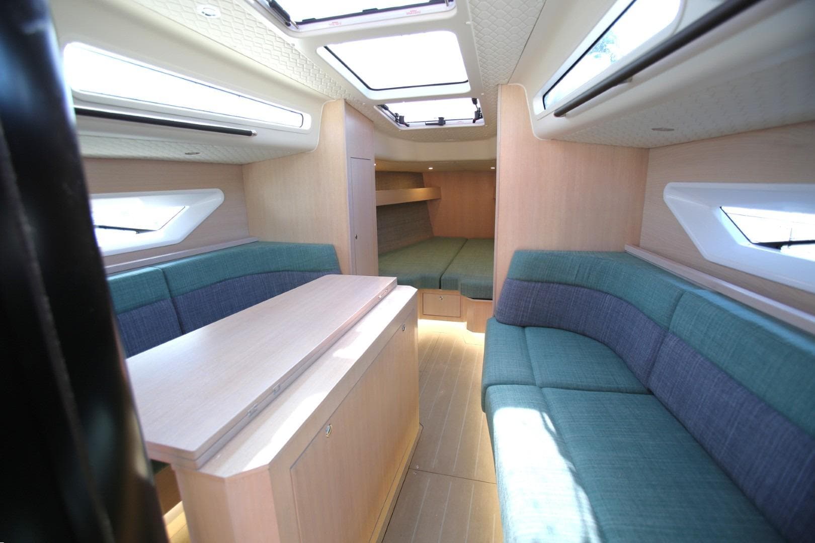 Luxurious interior of 2025 Shogun 43 yacht with modern seating and skylights.