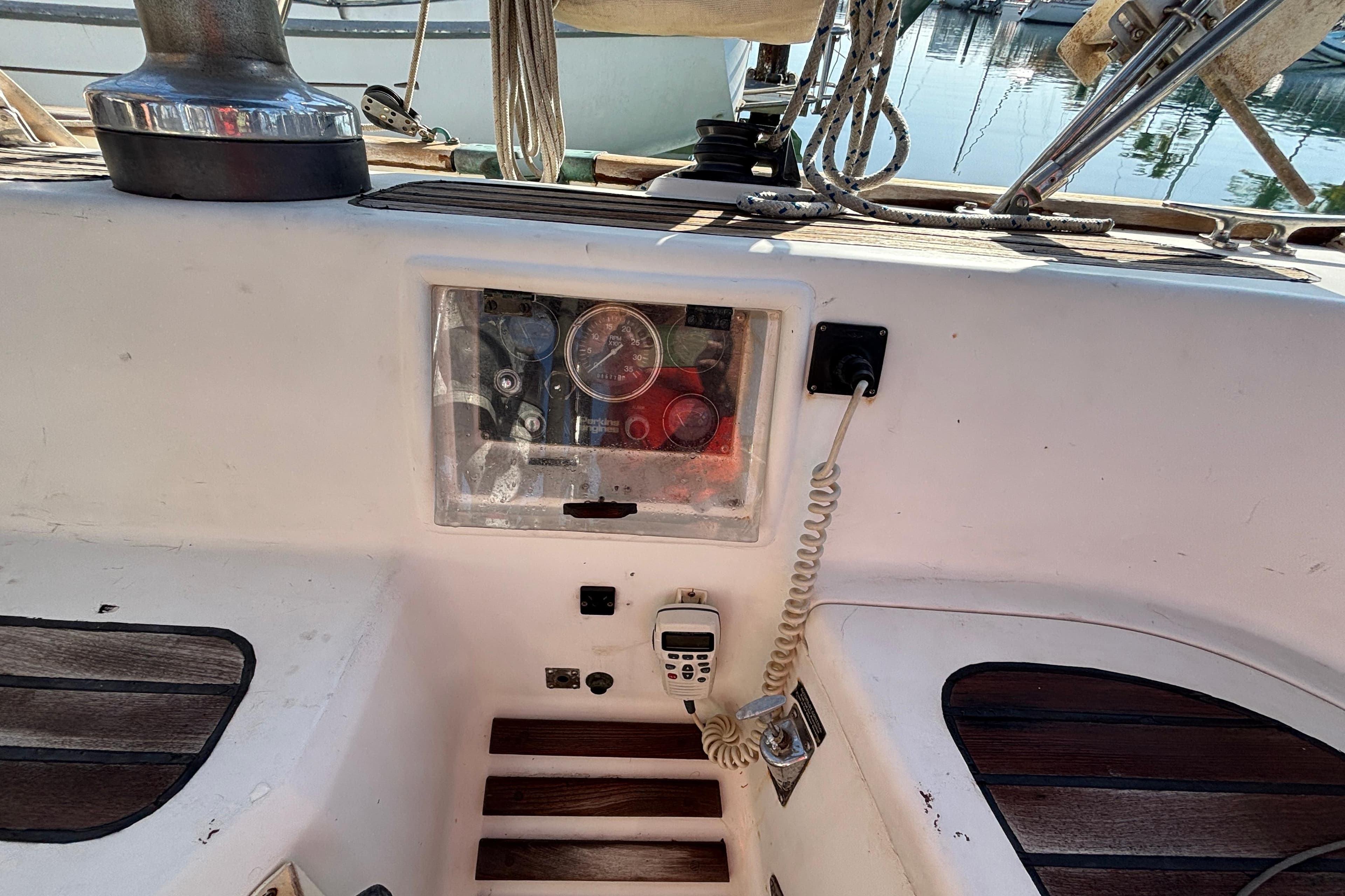 Cockpit of 1986 Passport 40 sailboat with control panel and communication device.