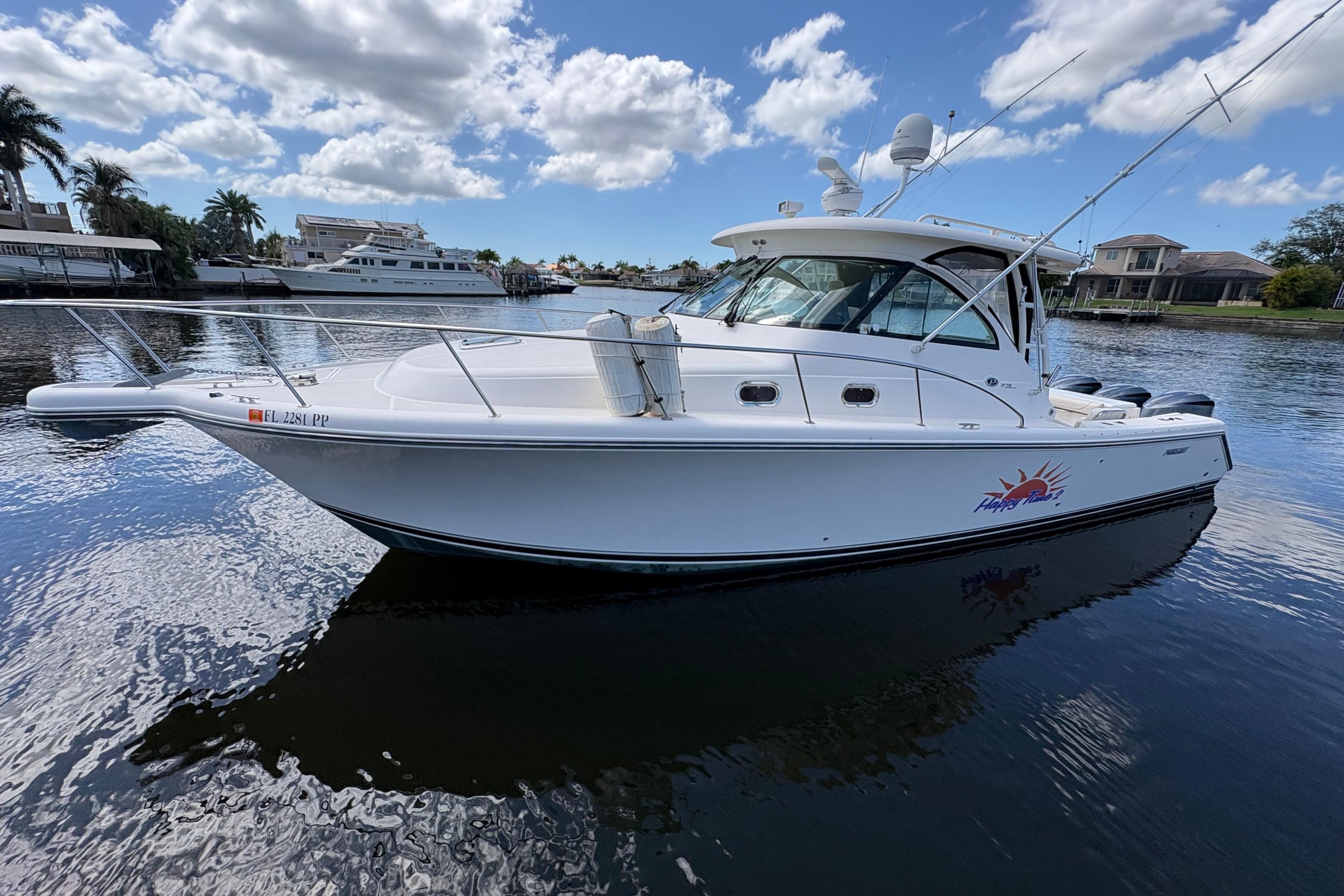 2011 Pursuit OS 375 Offshore boat on calm water under a partly cloudy sky.