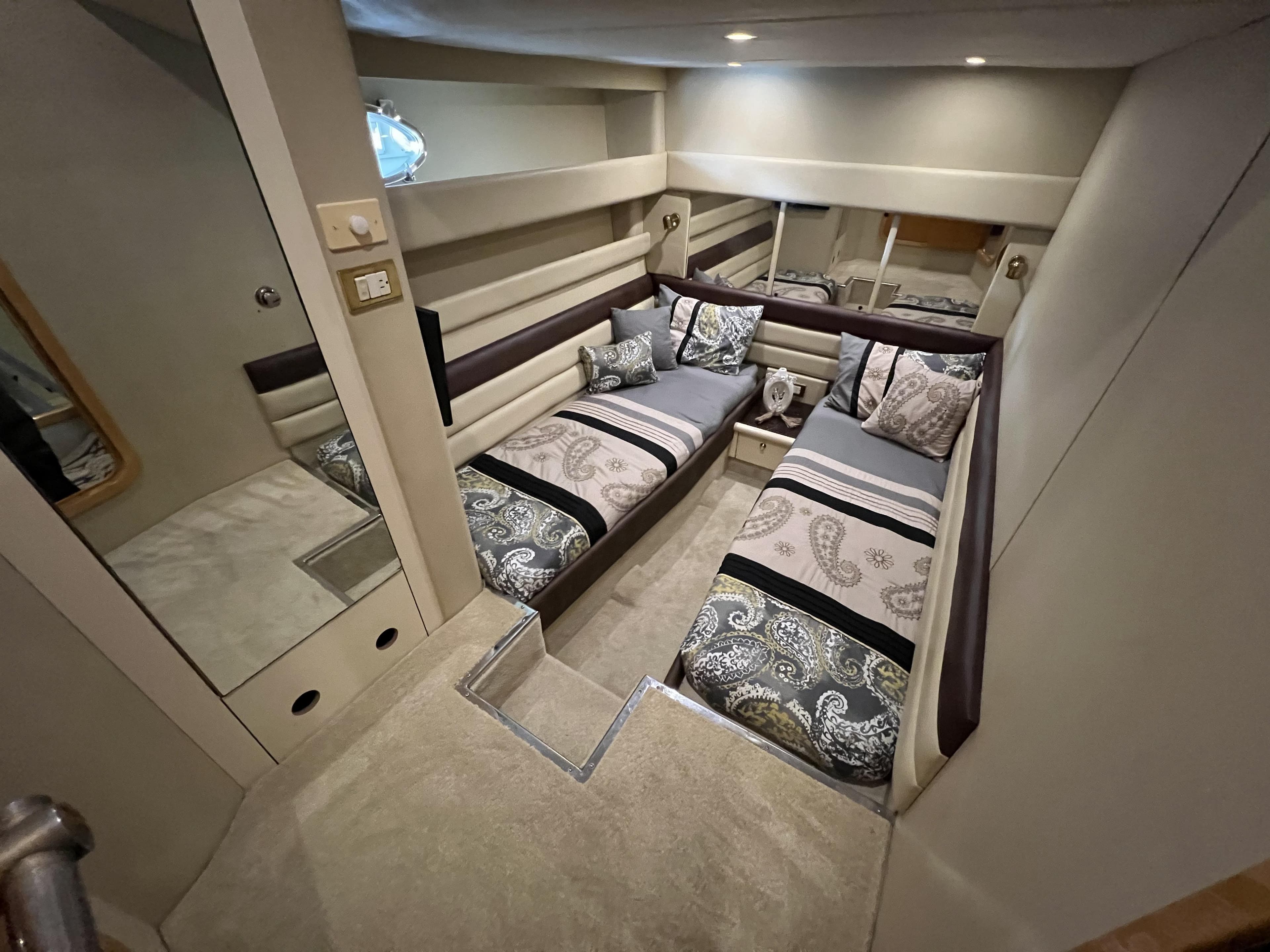 Luxurious interior of 1994 Sunseeker Camargue 55 yacht with twin beds and elegant decor.
