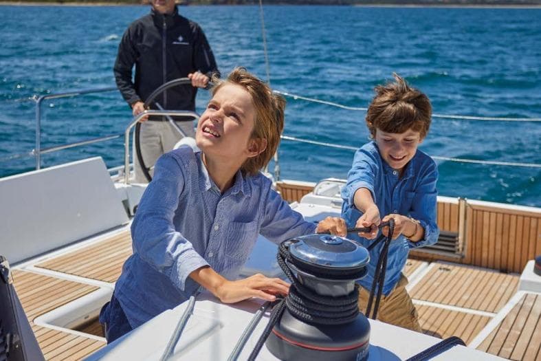 Children enjoying sailing on a 2026 Jeanneau Sun Odyssey 455 yacht.
