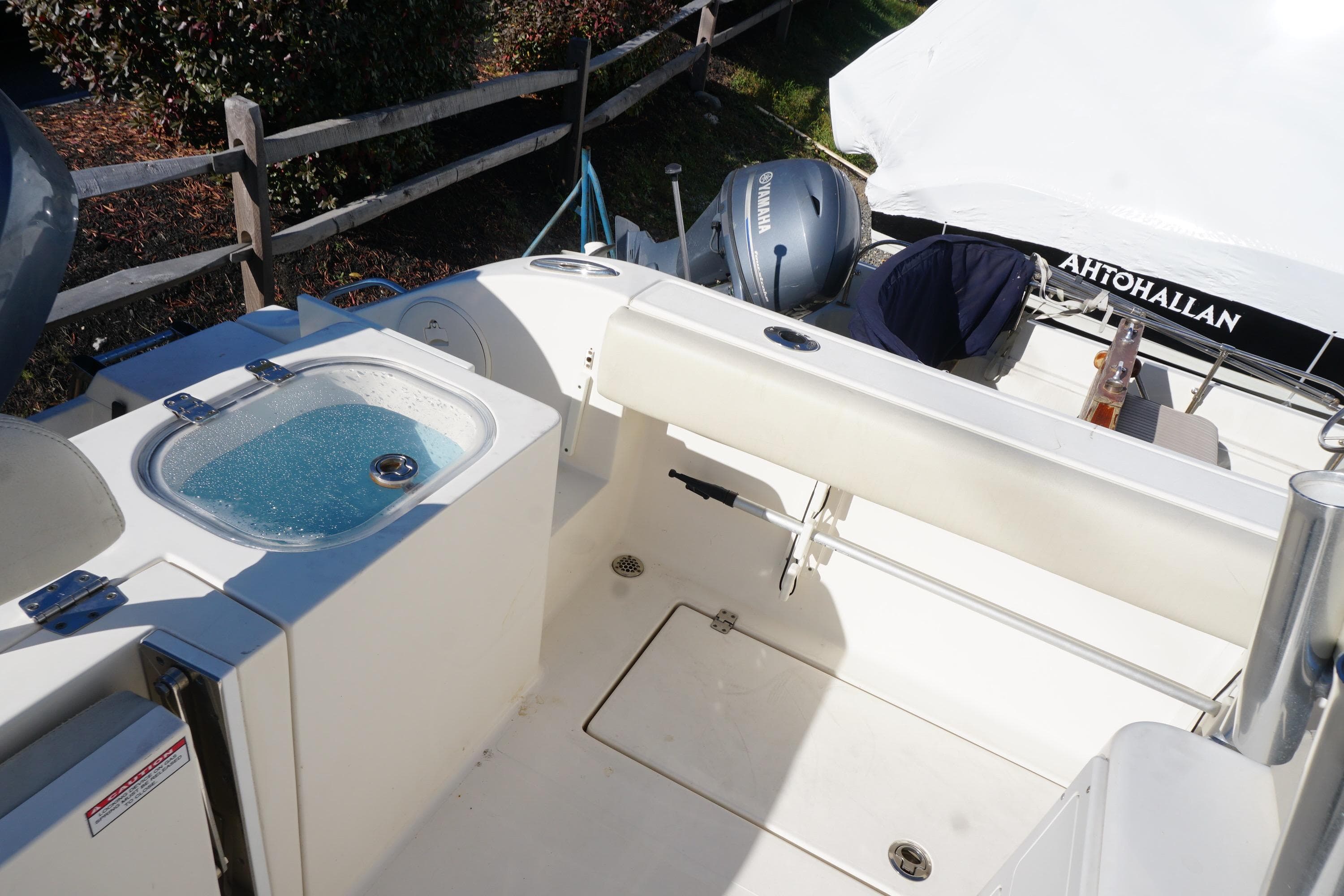 2019 Cobia 237 Center Console boat interior with Yamaha engine and livewell.