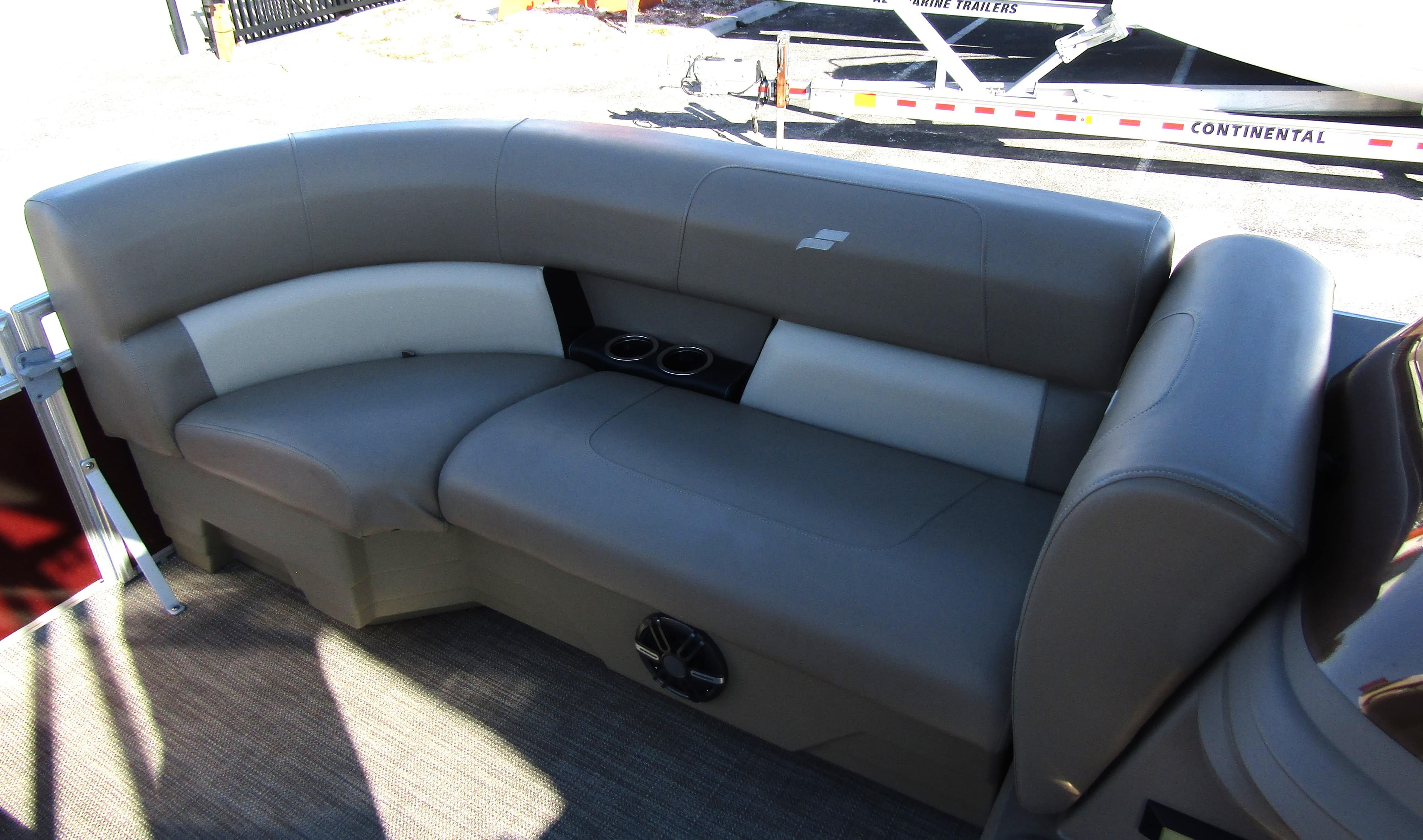 2024 Starcraft LX 20 R pontoon boat interior with gray seating and cup holders.
