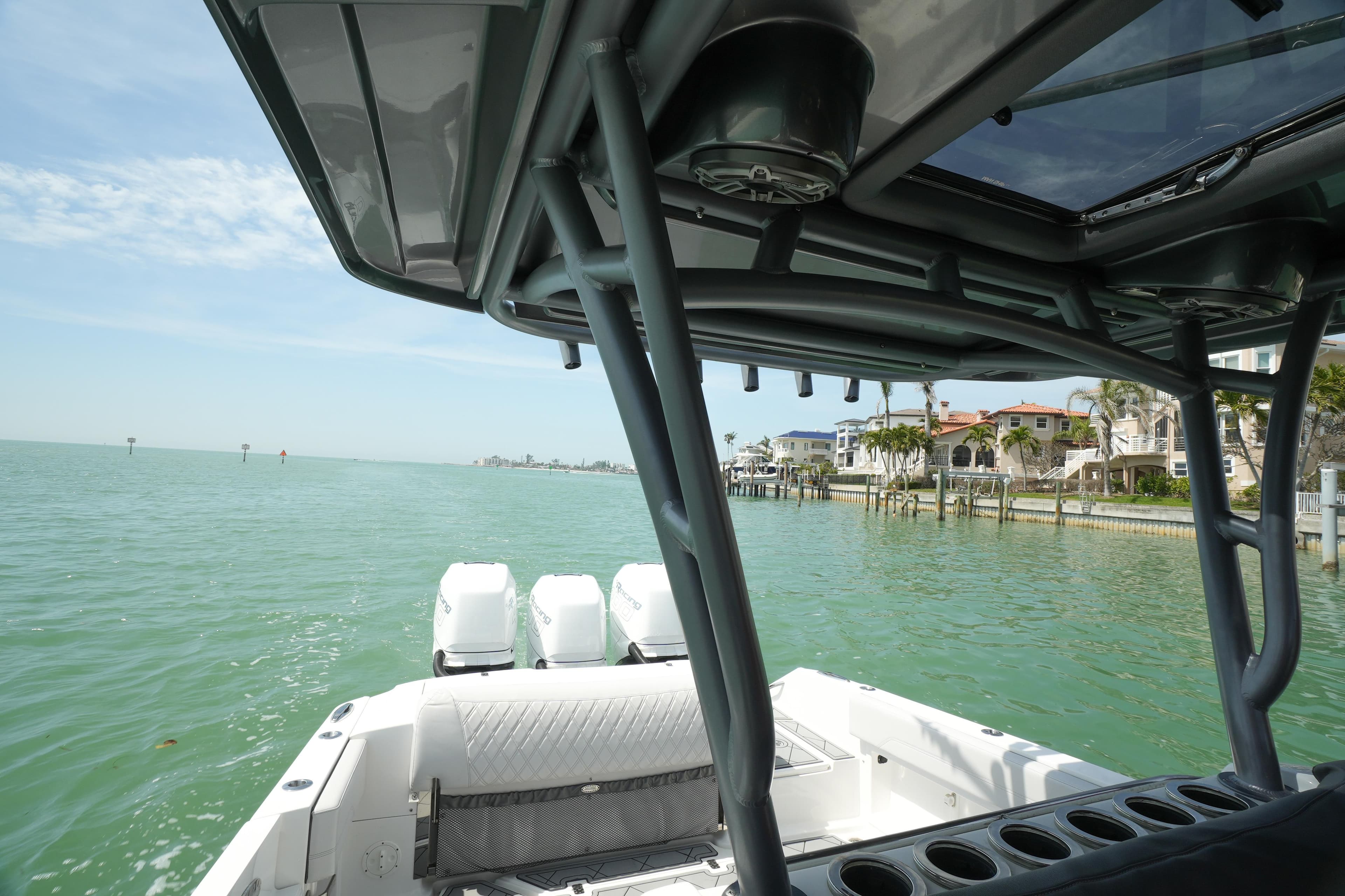 2020 Nor-Tech 390 Sport Center Console on calm waters near coastal homes.