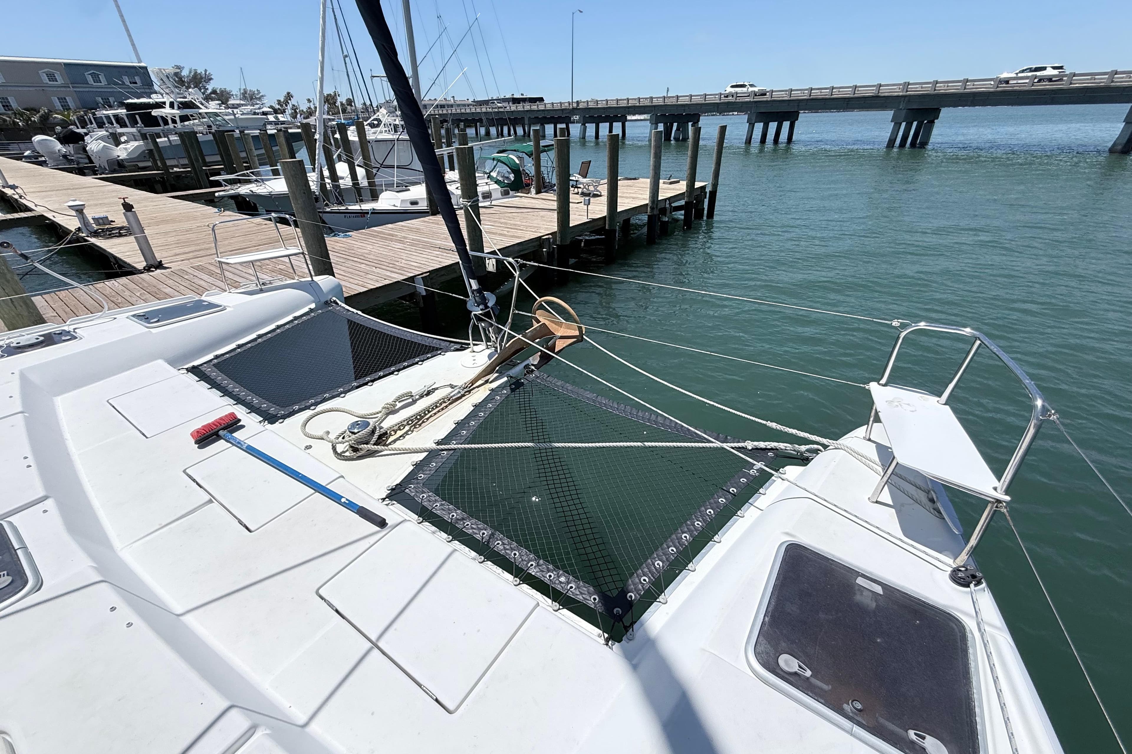 2008 Lagoon 420 catamaran docked at marina with bridge in background.