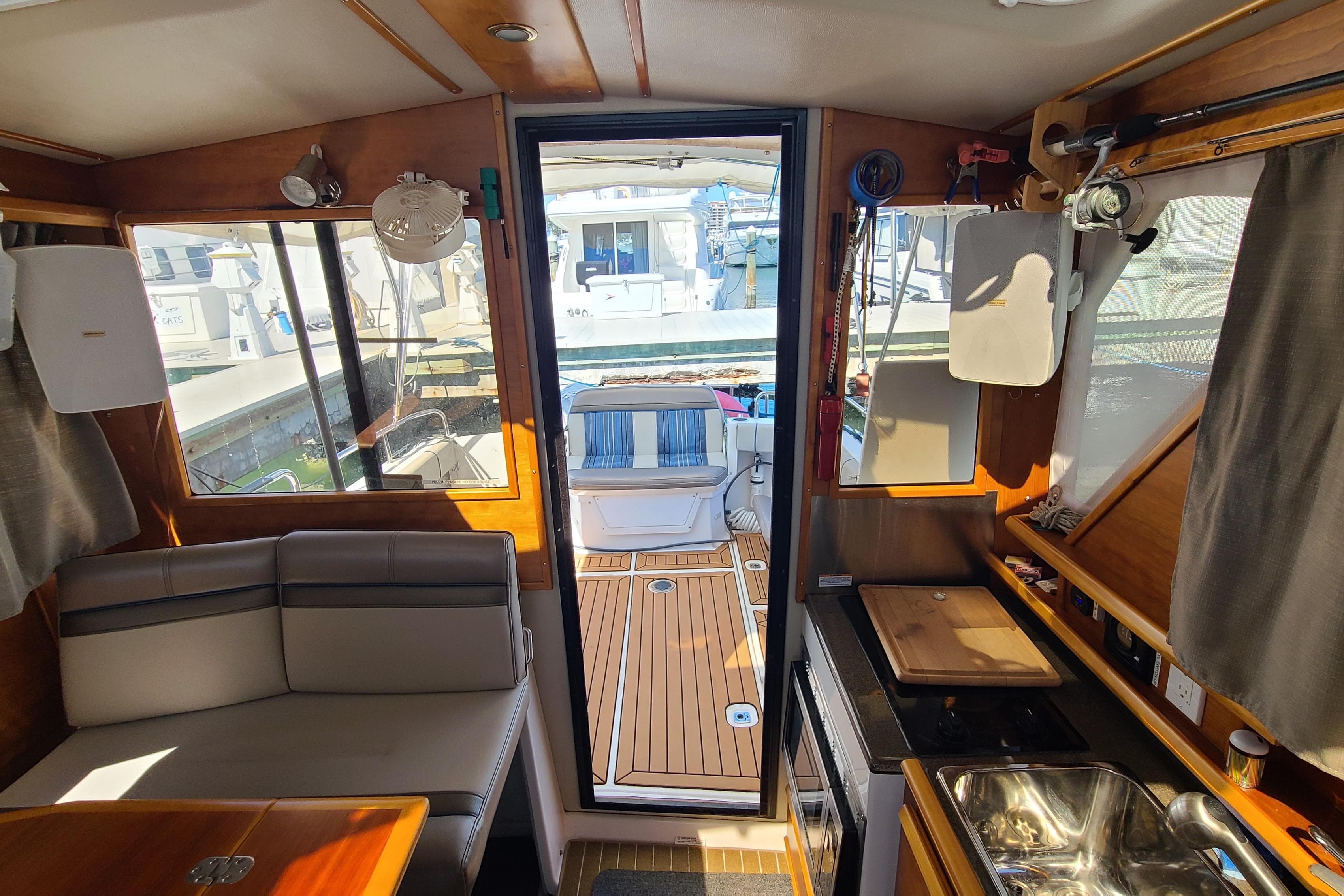 Interior of a 2019 Cutwater C-28 LE boat, featuring seating and kitchenette.