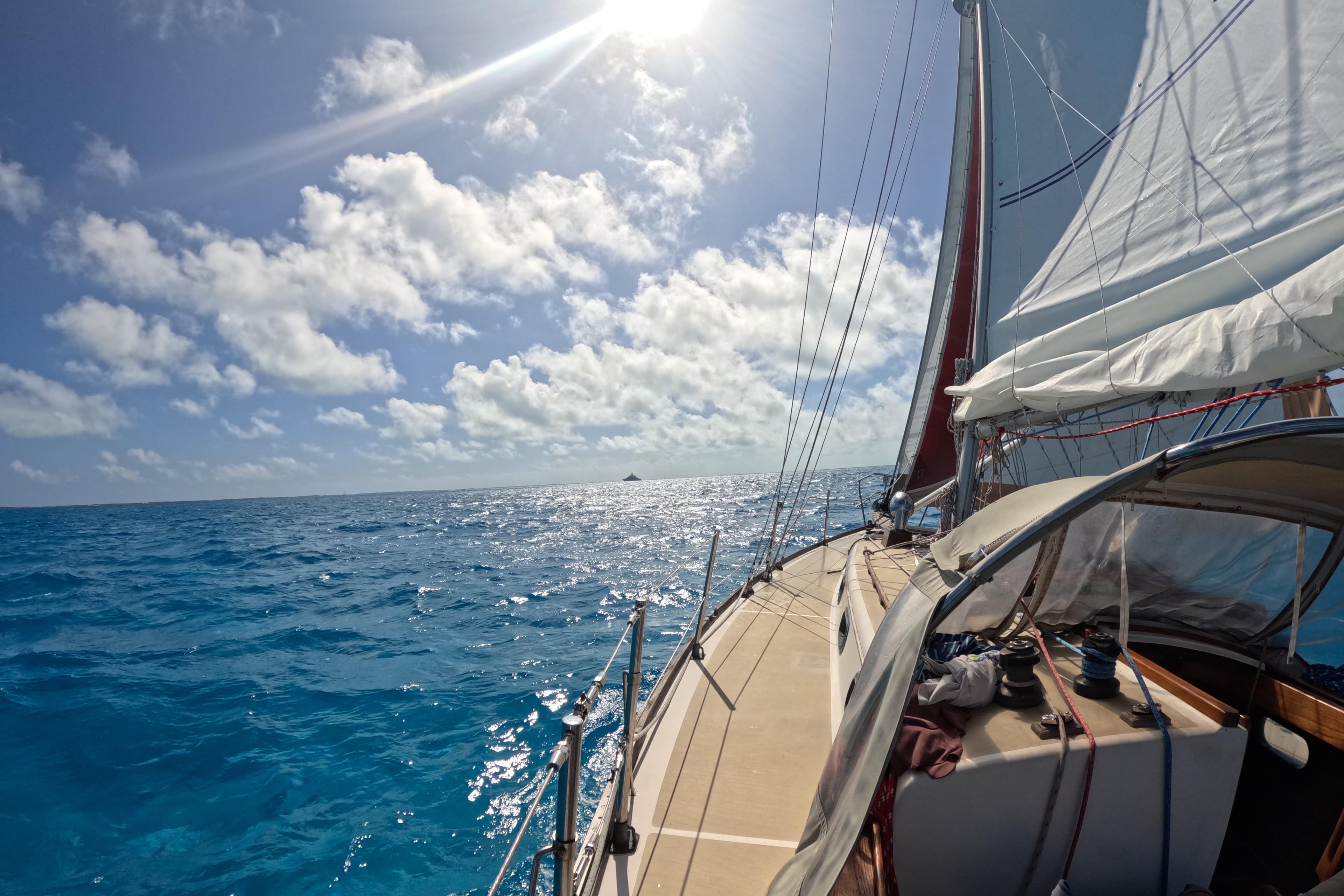 Sailing on a 1988 Cape Dory 36 under sunny skies and blue ocean waters.