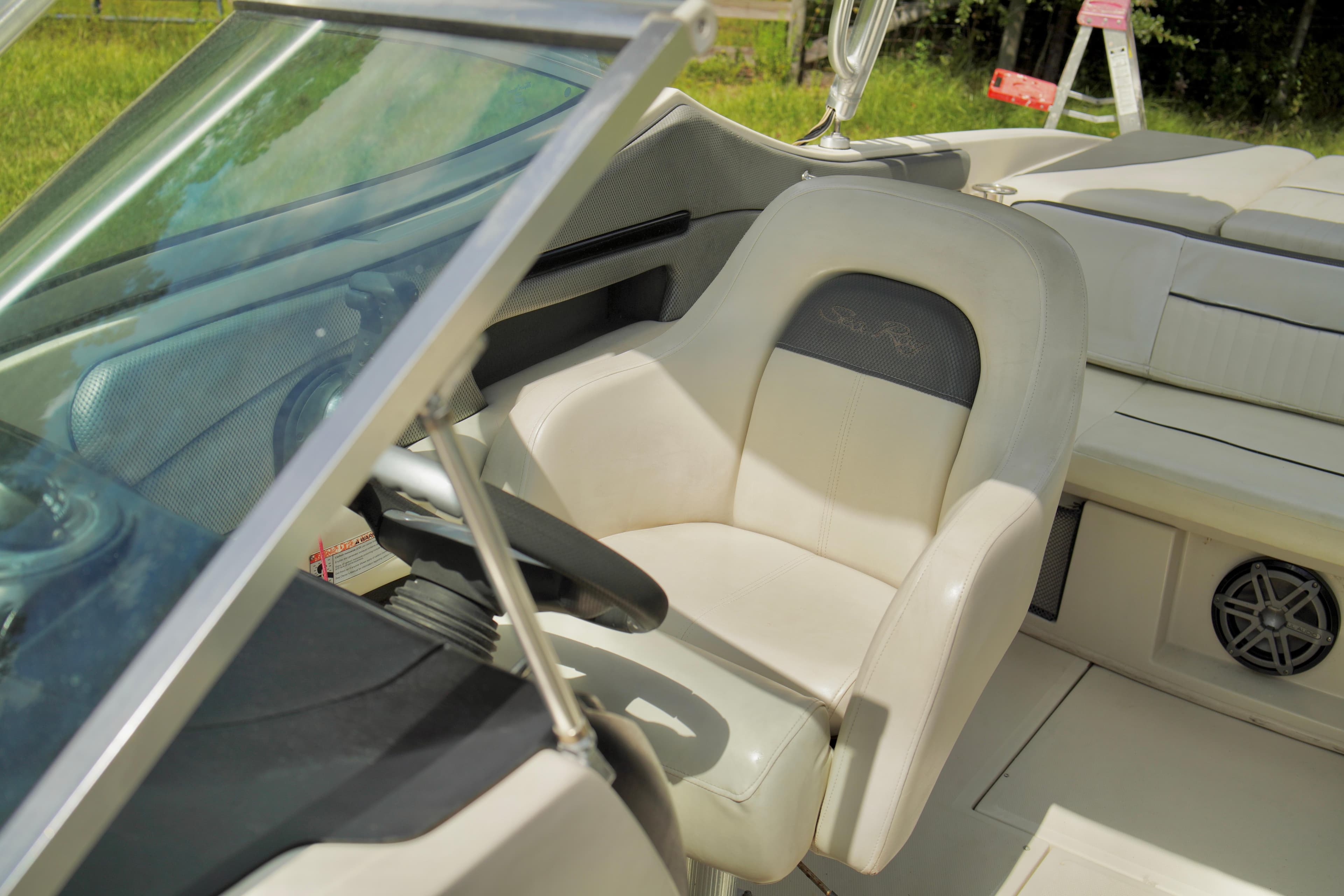 2008 Sea Ray 230 Select Fission boat interior with captain's chair and steering wheel.