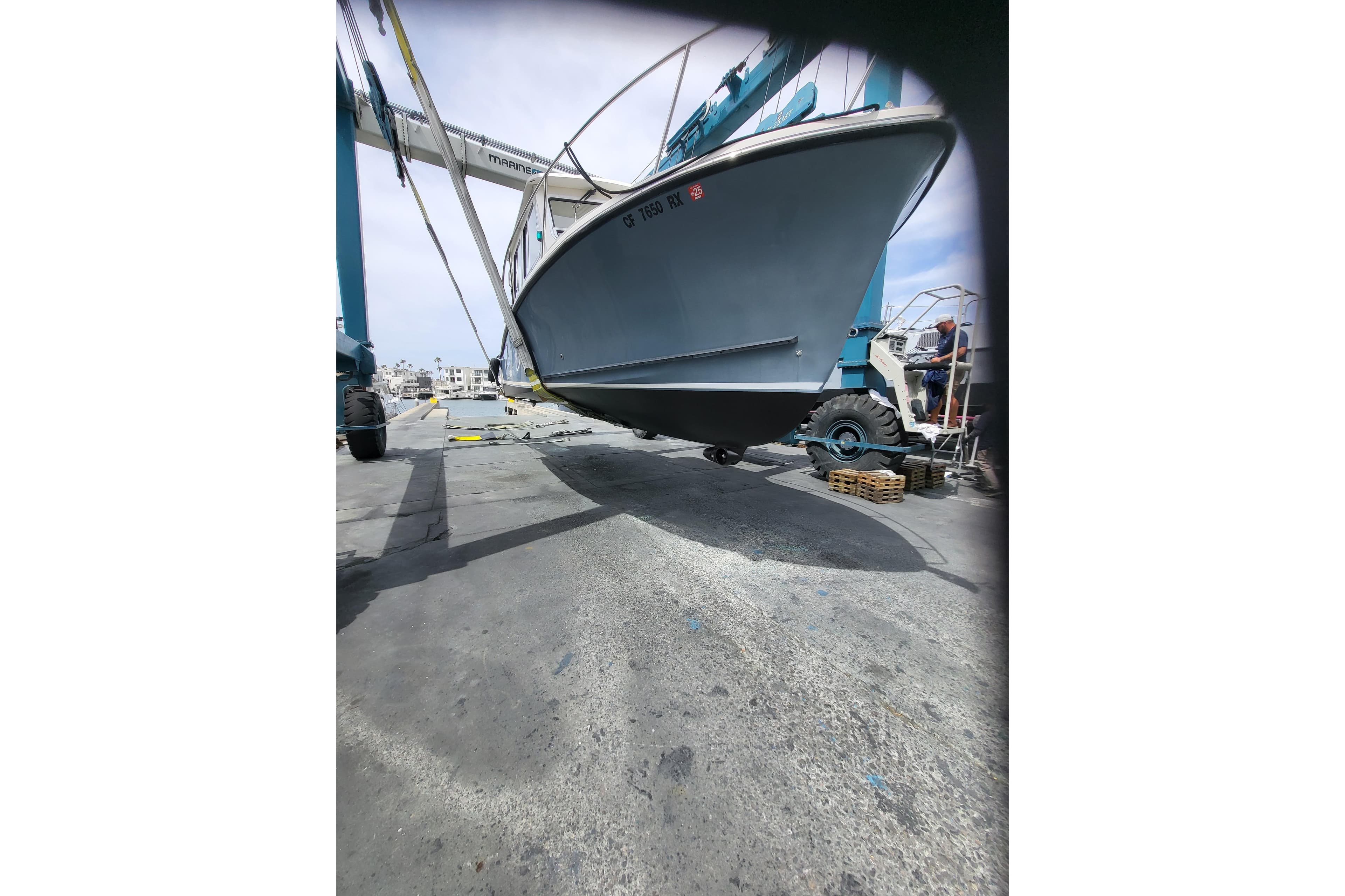 2015 Eastern Islander 270 boat being lifted at a marina.
