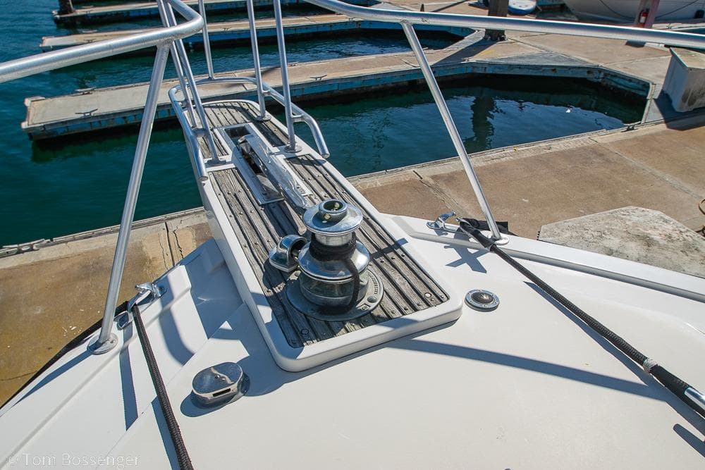 Bow of 1989 Bertram 50 Convertible yacht at marina dock.