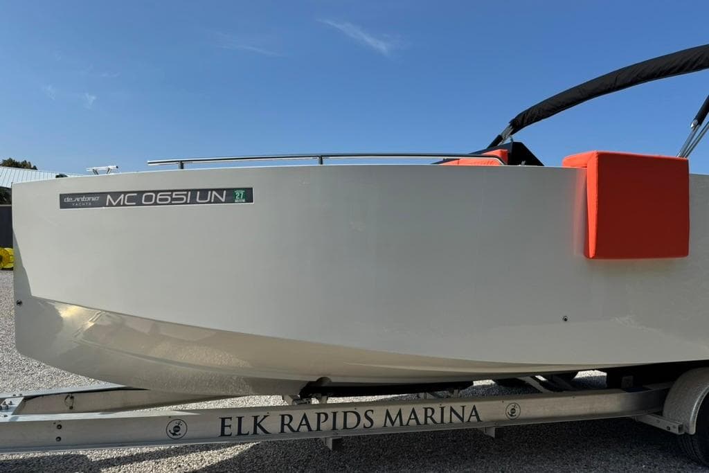 2020 De Antonio Yachts D28 on trailer at Elk Rapids Marina under clear blue sky.