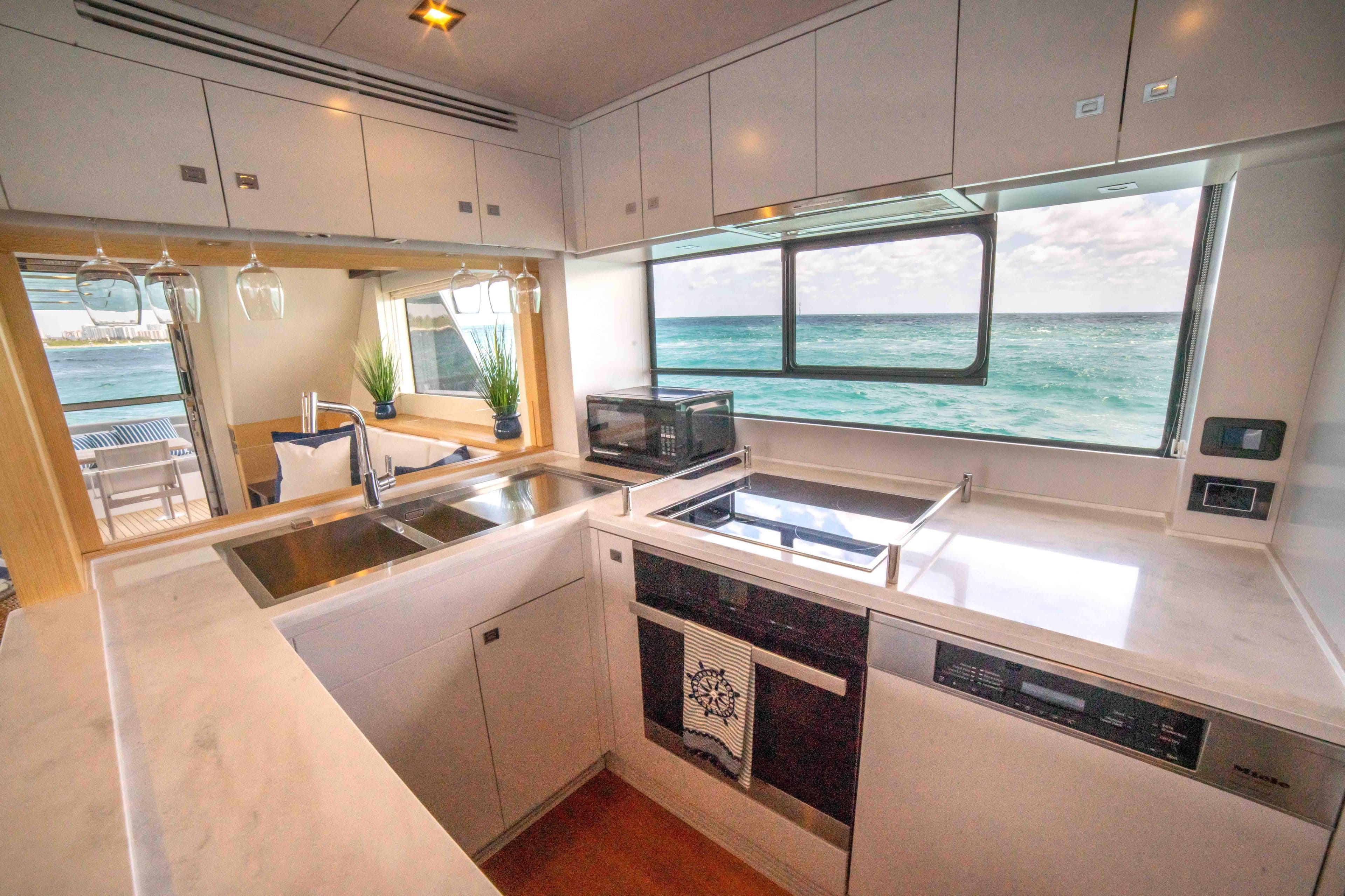 Modern kitchen in 2018 Sirena 64 yacht with ocean view.