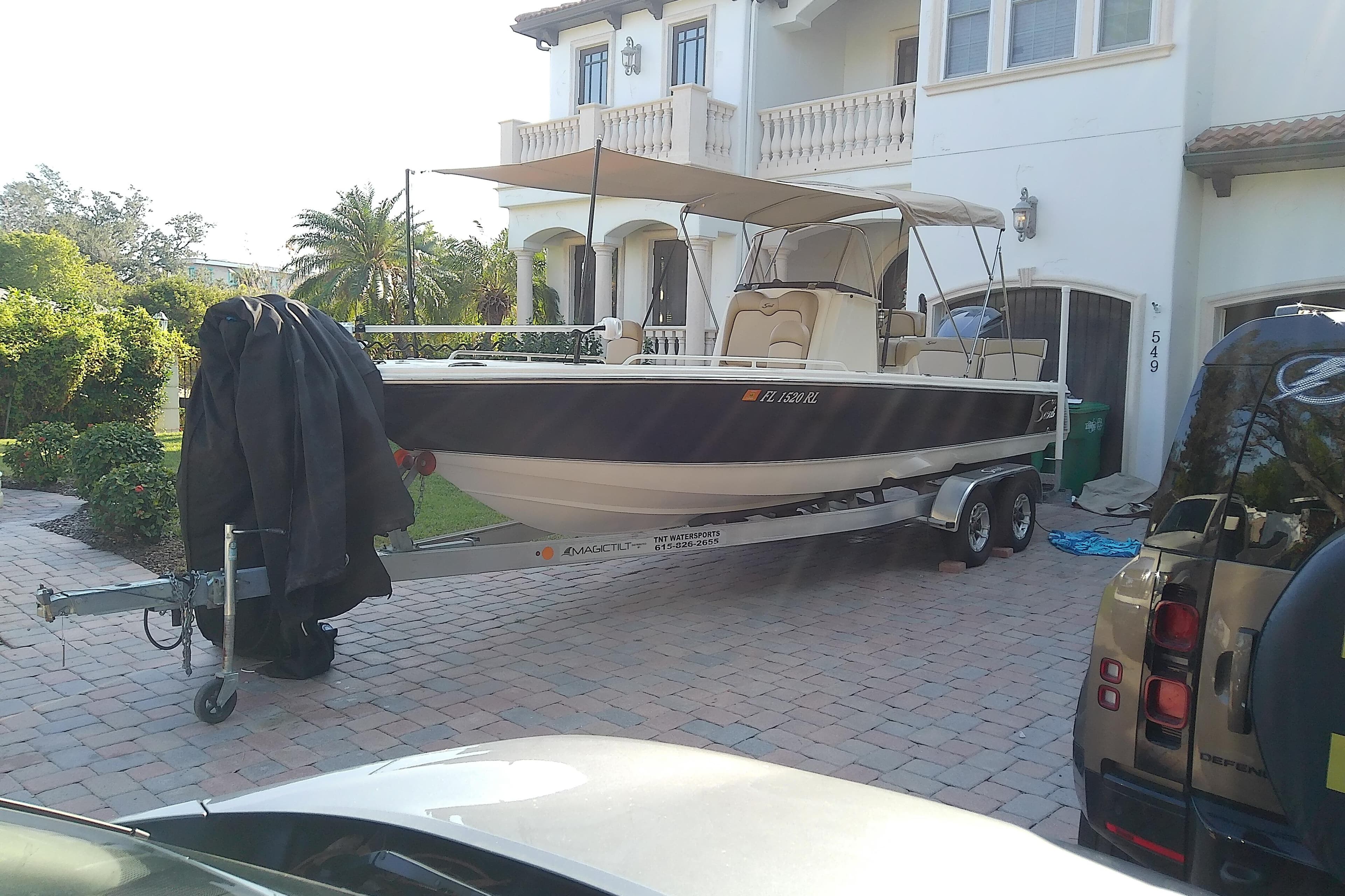 2018 Scout 251 XSS boat on trailer in residential driveway.
