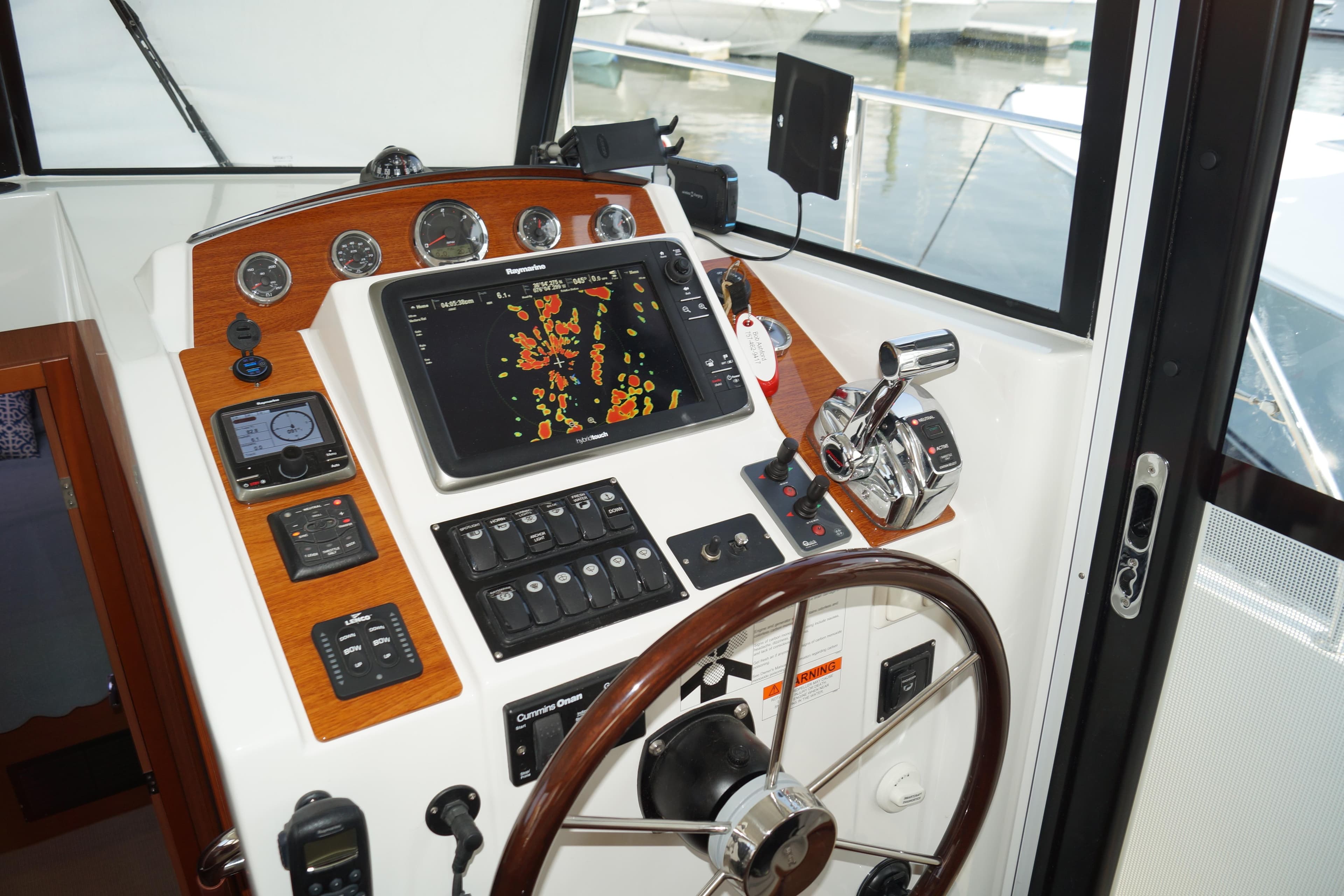 2014 Beneteau Swift Trawler 34 helm with navigation controls and steering wheel.