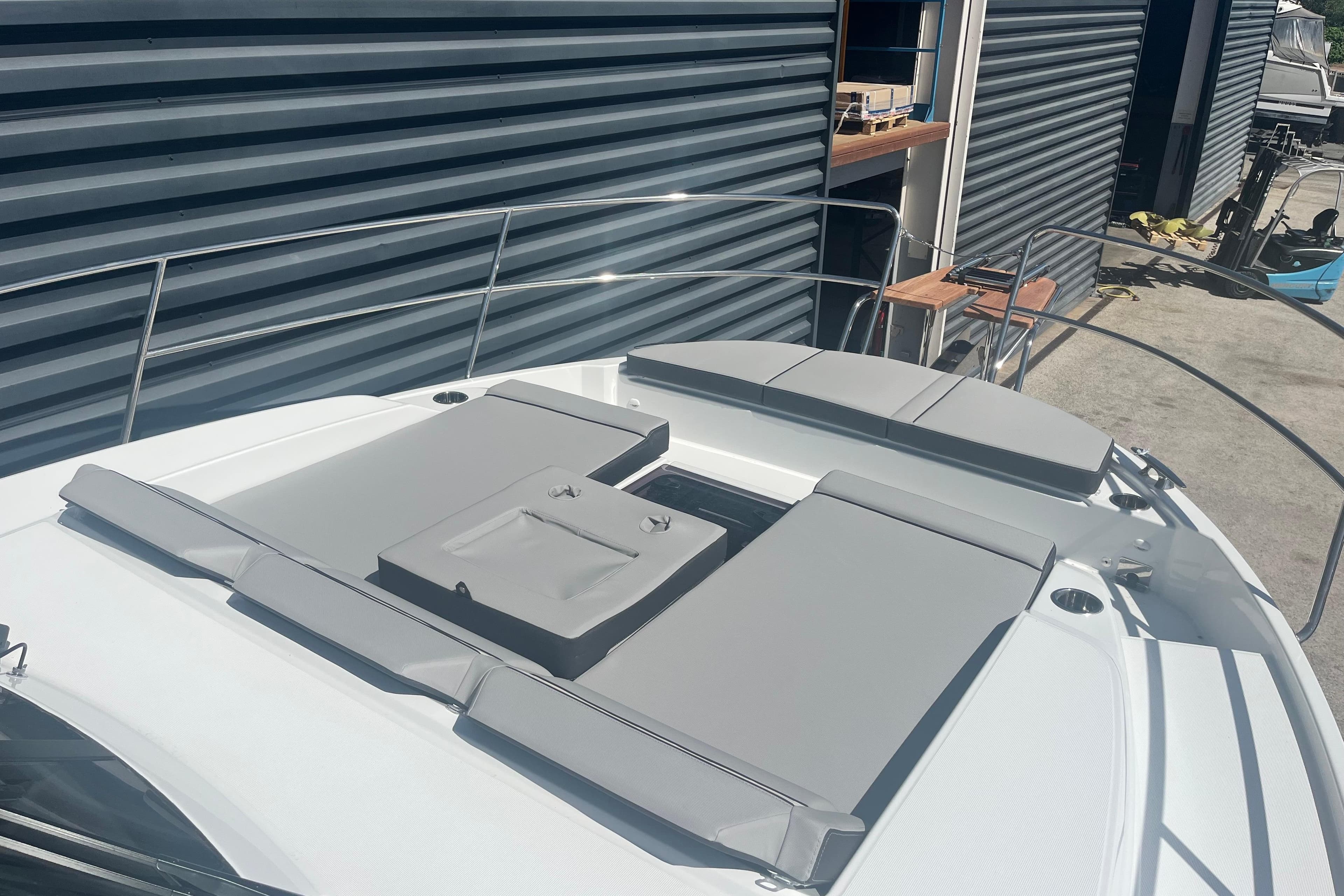 2026 Jeanneau Merry Fisher 1095 boat with sunbathing cushions on deck.