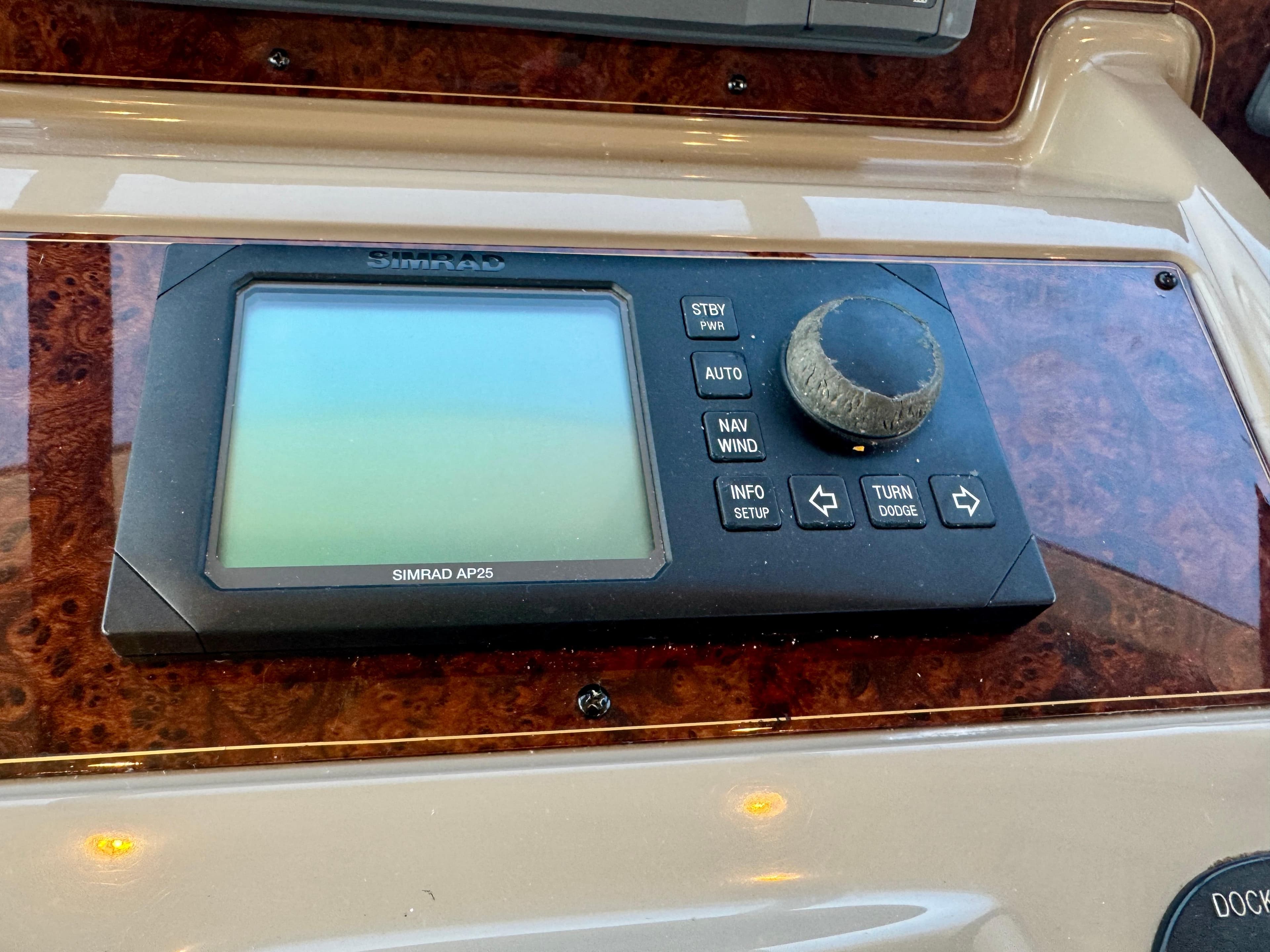 Control panel of a 1999 Bayliner 5288 Pilot House Motoryacht with Simrad AP25 display.