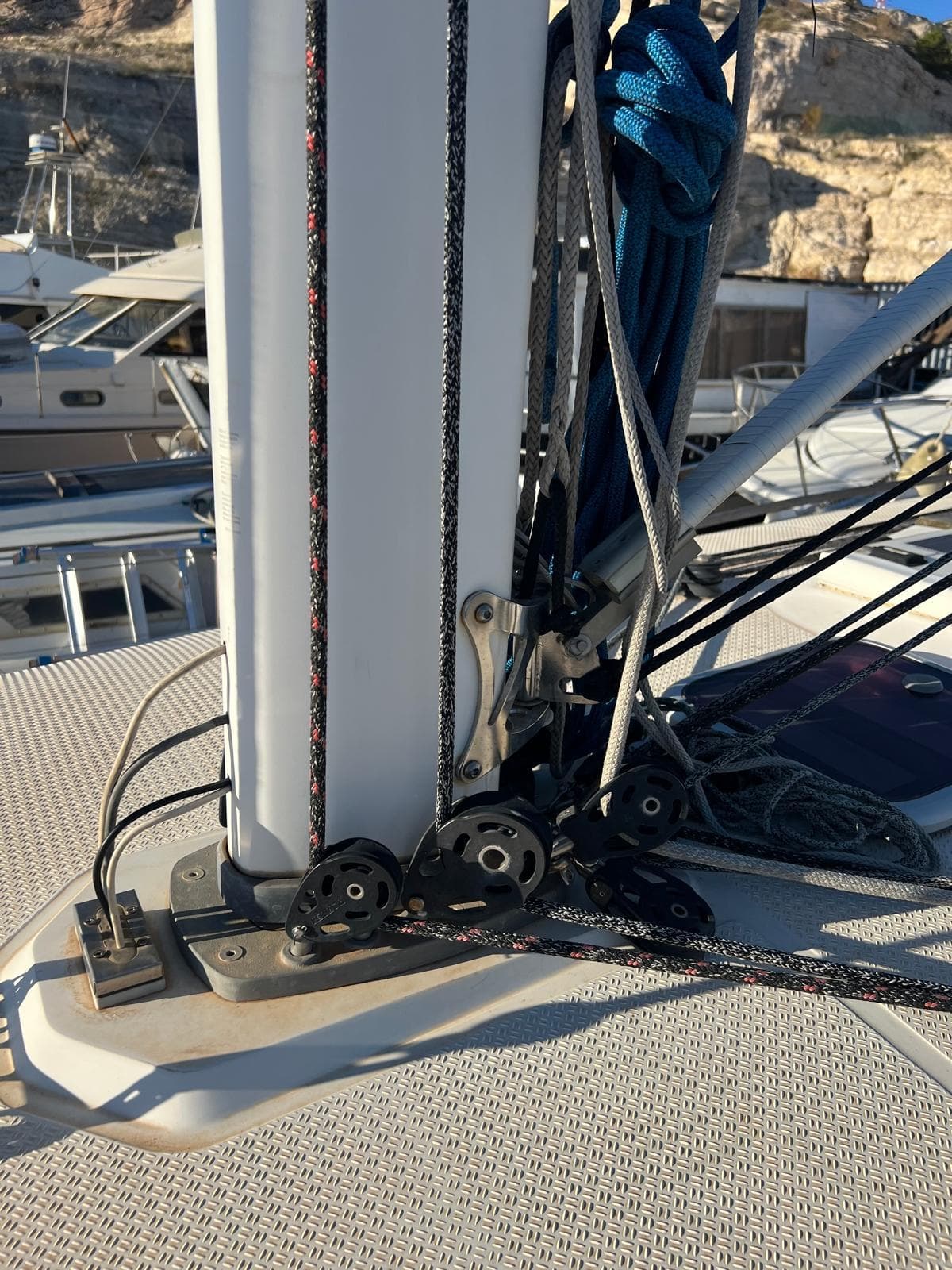 Sailboat rigging on a 2003 Wauquiez Opium 39, docked with visible ropes and pulleys.