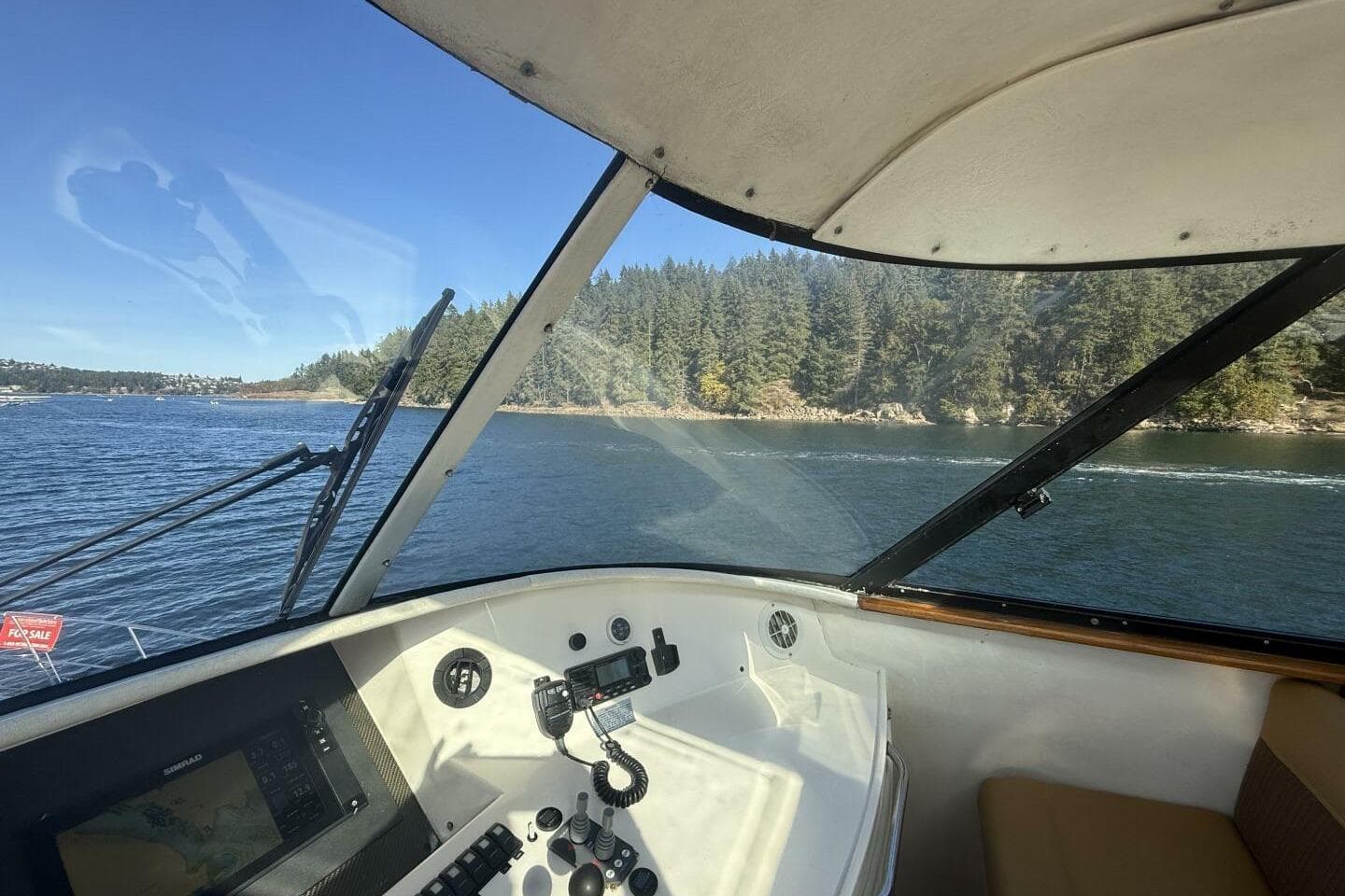 Interior view of 2000 Royal Pacific 476 Sport Cruiser navigating a scenic waterway.