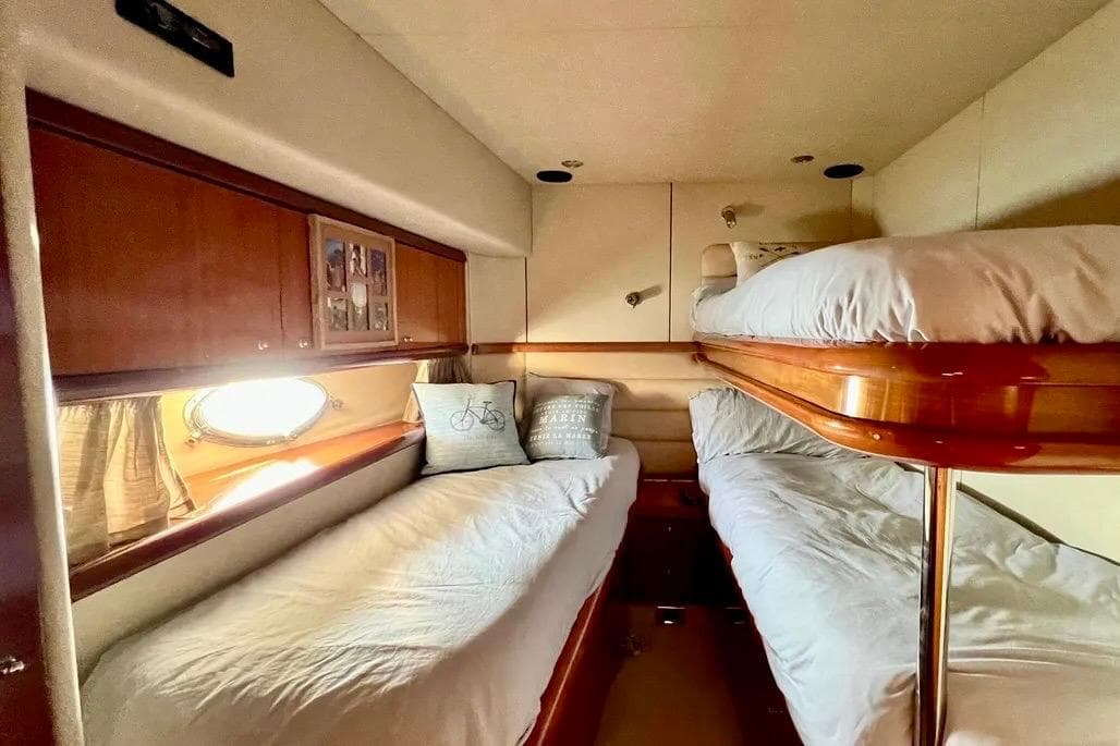 Cozy cabin with bunk beds in 2002 Sunseeker Manhattan 64 yacht.