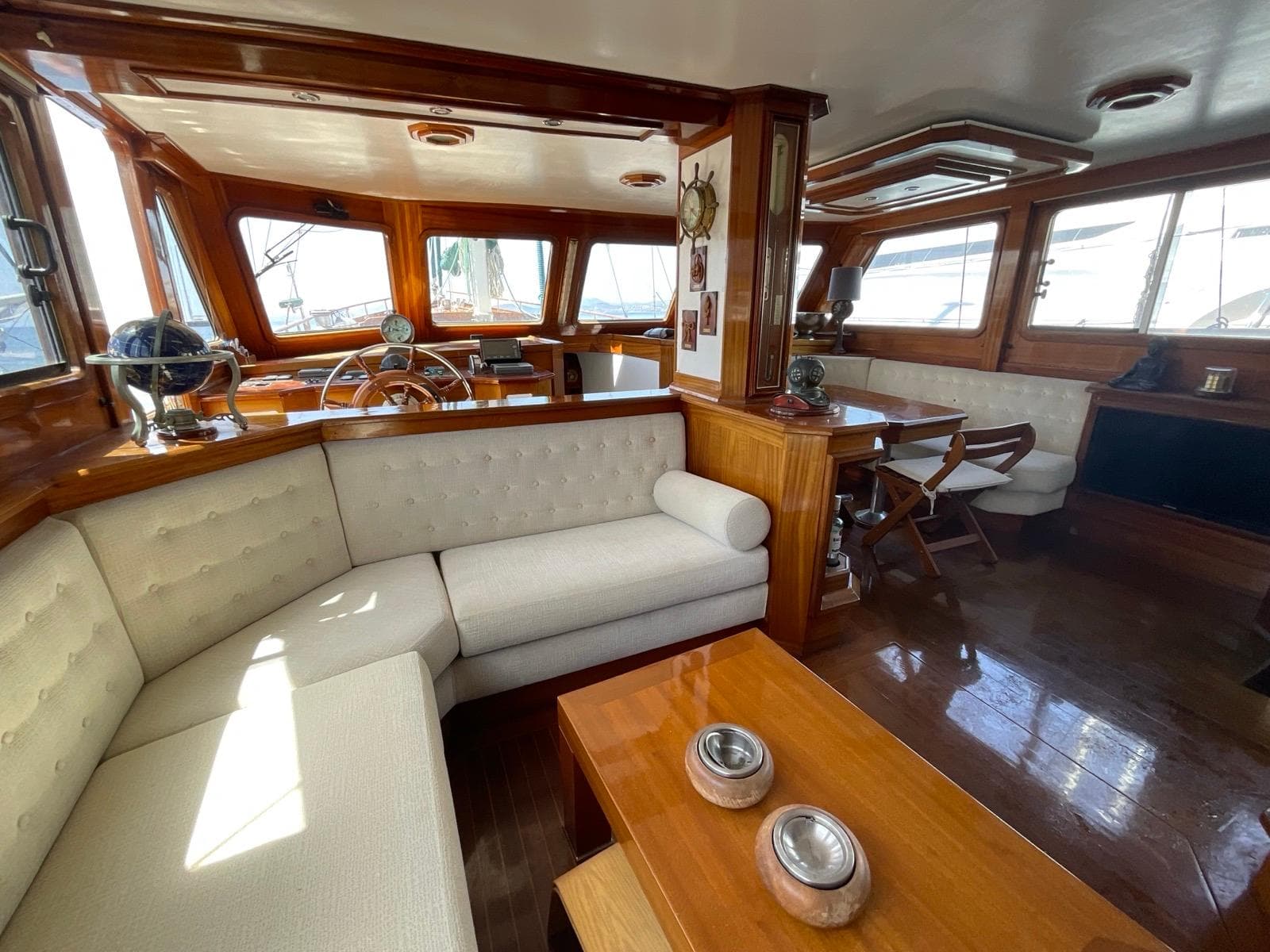 Luxurious interior of a 1999 Custom Classic Schooner with elegant wood and plush seating.