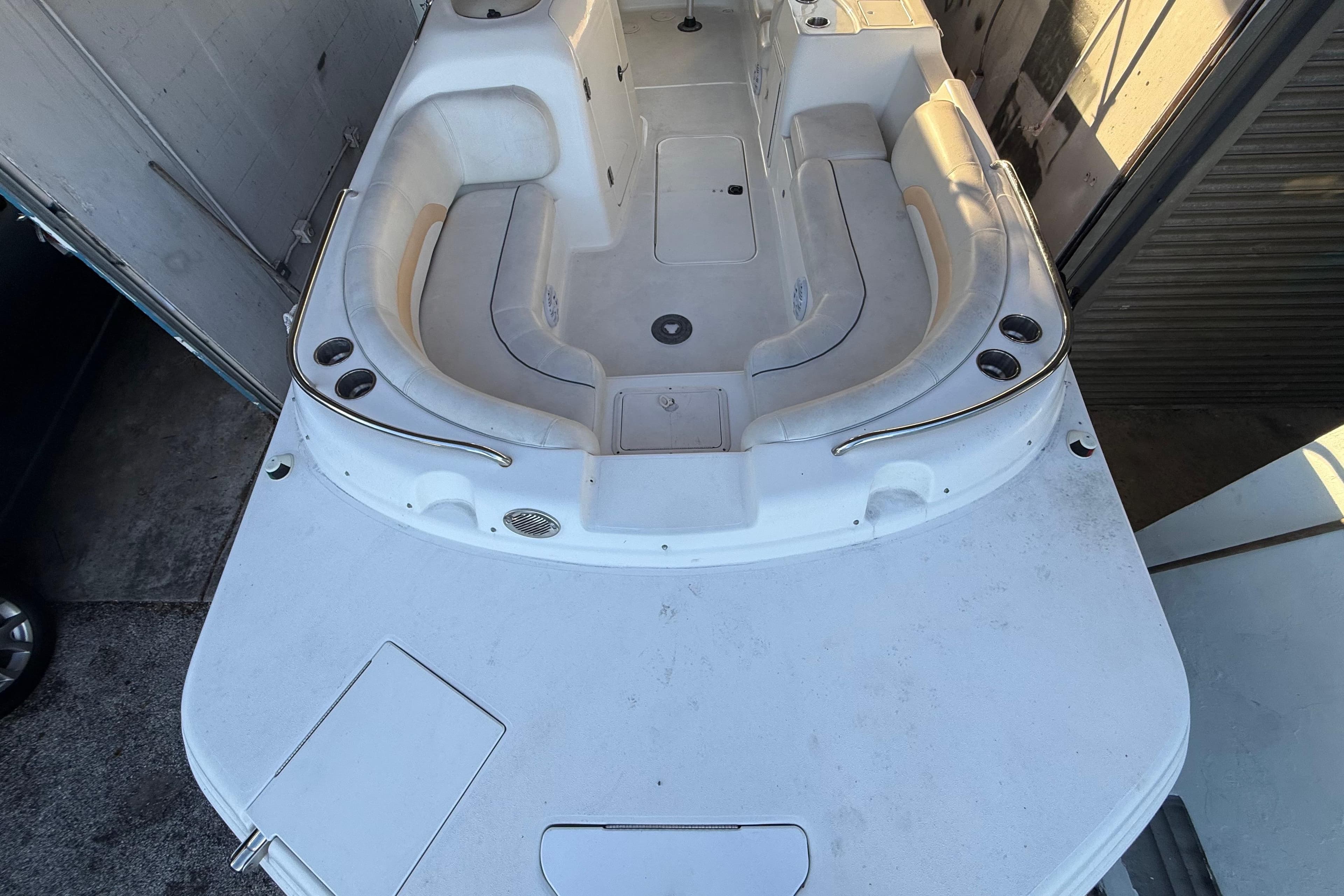 2016 Hurricane SunDeck Sport 232 OB boat interior with spacious seating and cup holders.