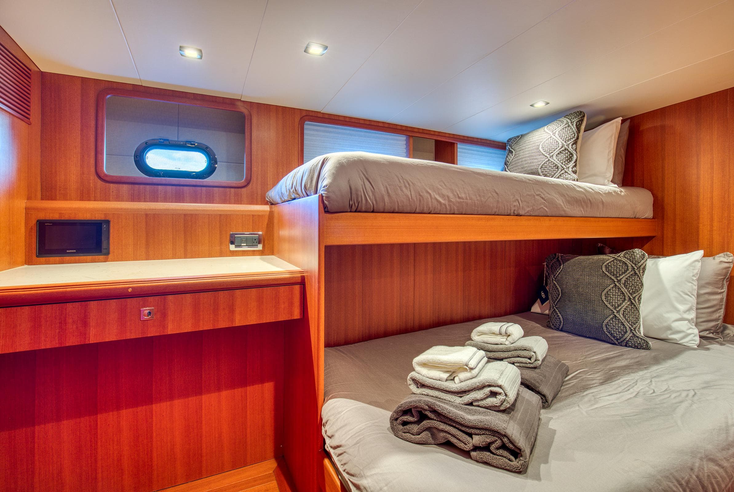 Cozy cabin with bunk beds in 2025 Hampton 750 Endurance LRC yacht.