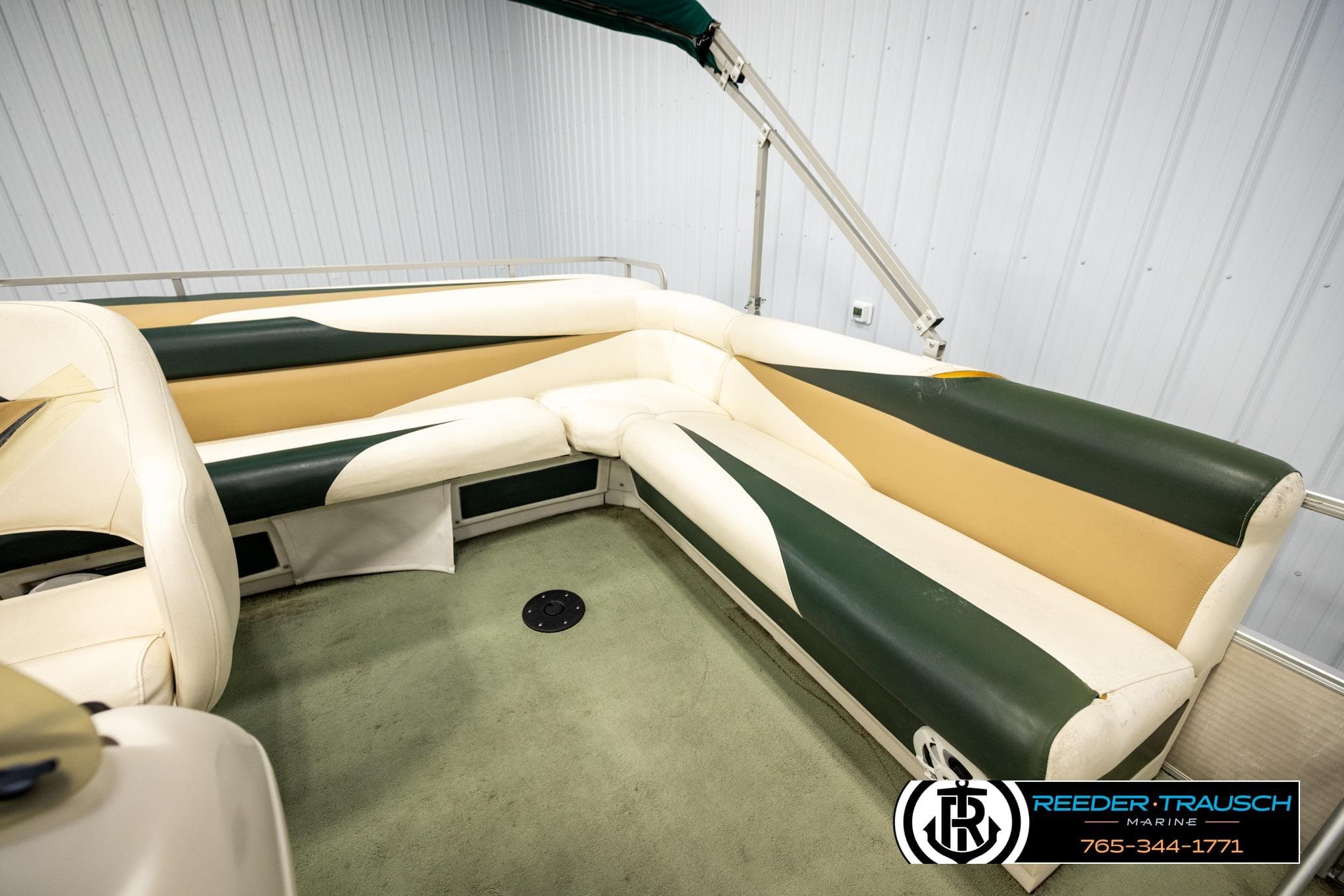 2003 Godfrey Sweetwater 60 boat interior with green and beige seating.