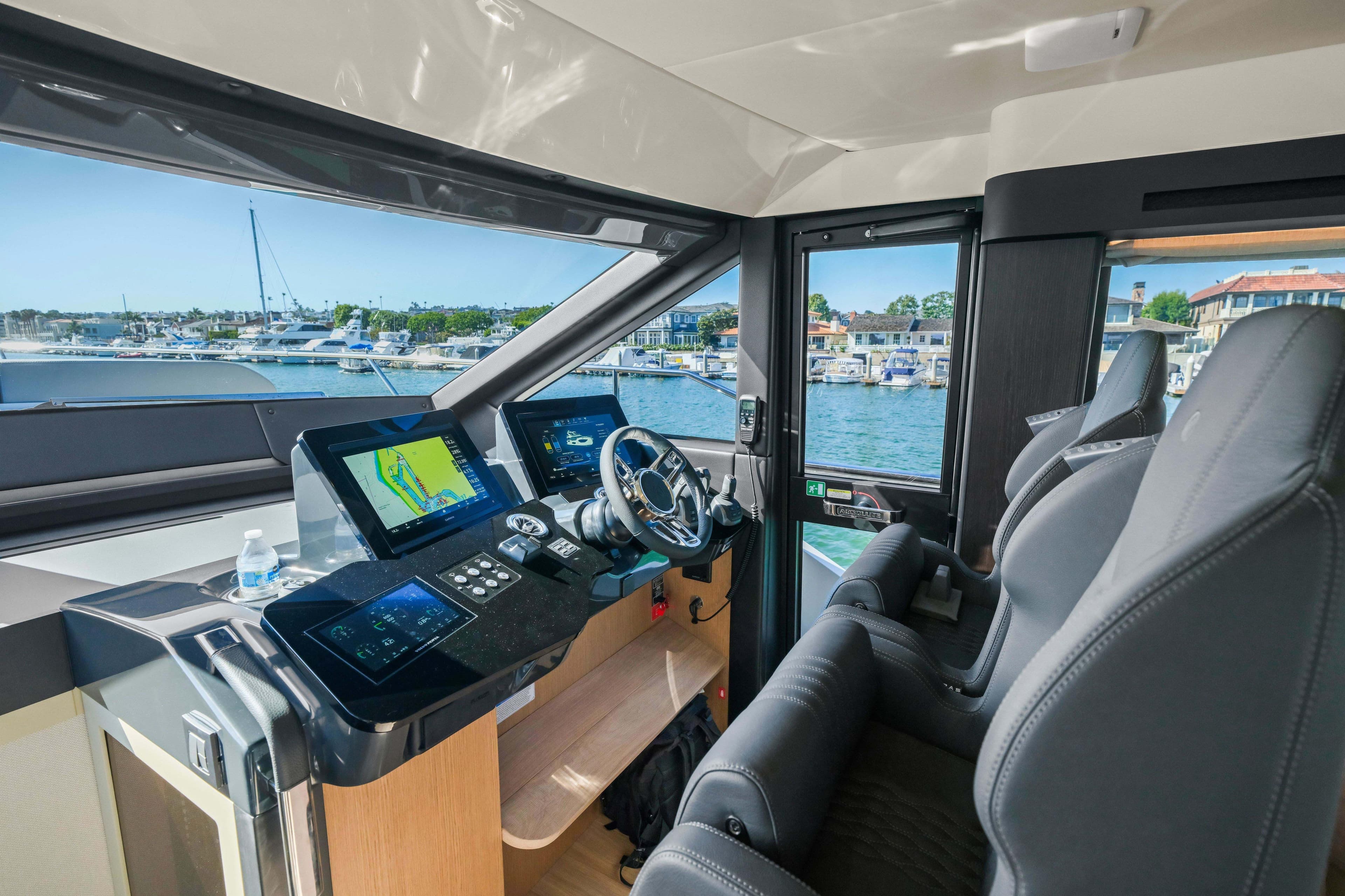Interior view of 2026 Absolute 52 Fly yacht cockpit with modern navigation systems.