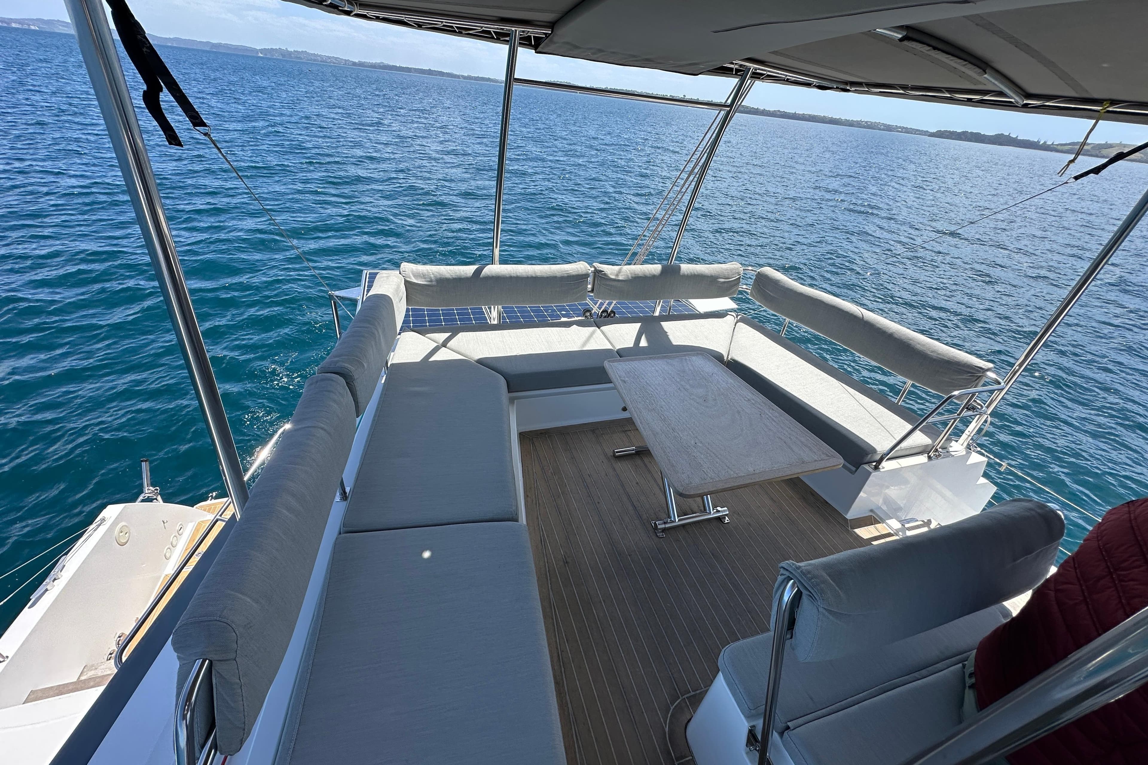 Spacious deck of 2021 Nautitech 46 Fly catamaran with ocean view.