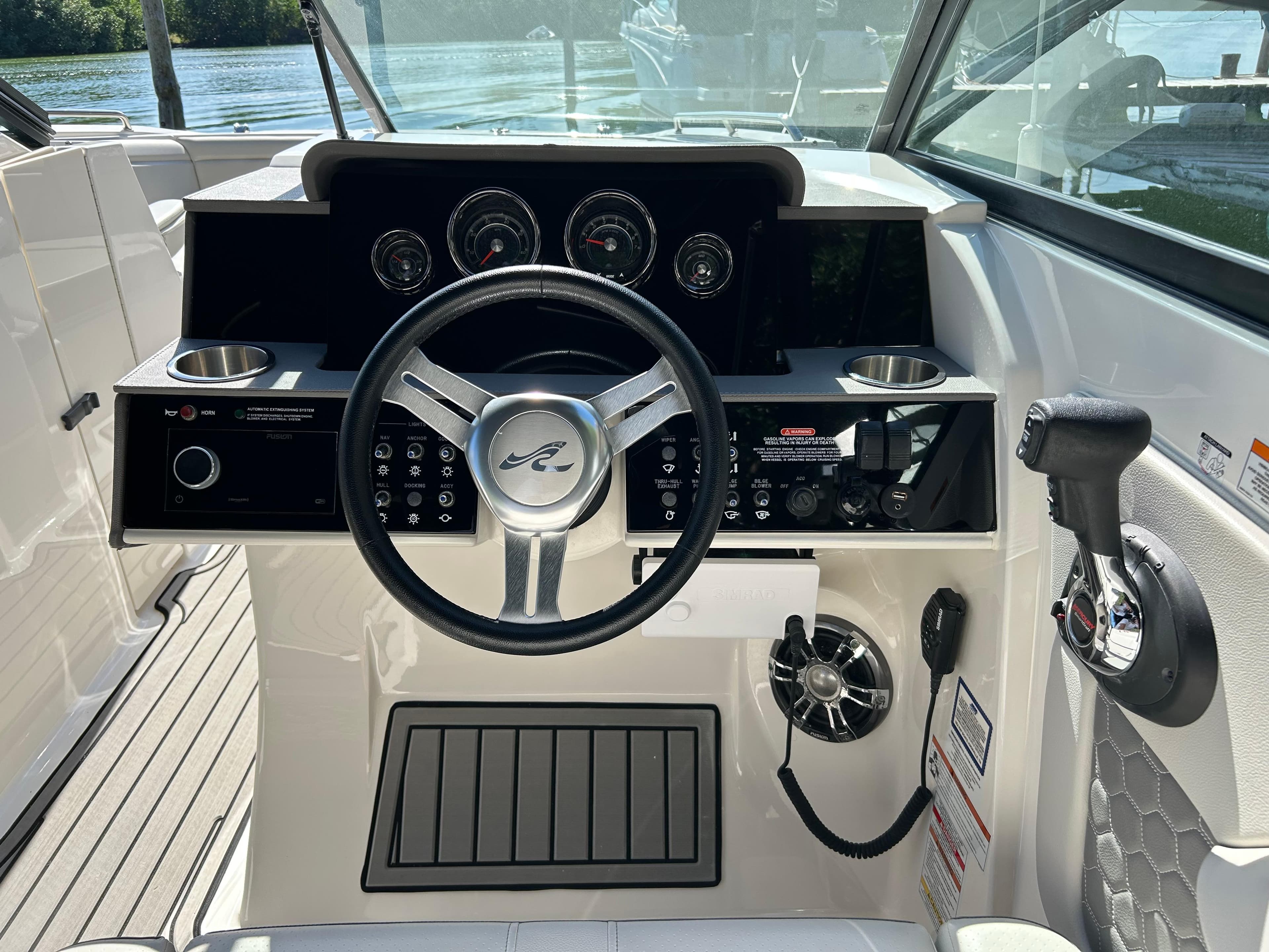 2022 Sea Ray SDX 290 helm with steering wheel, gauges, and controls.