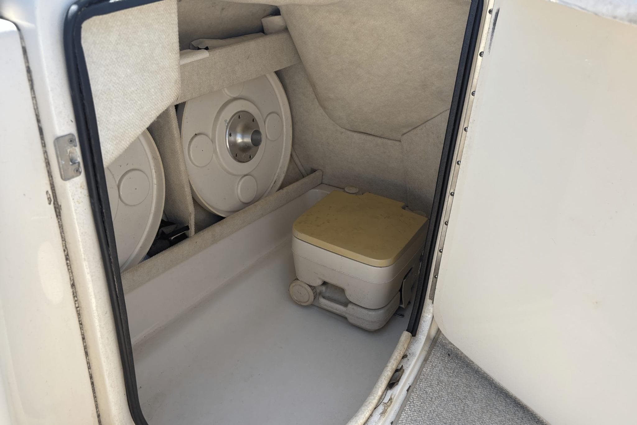 Interior storage compartment of a 2001 Sea Ray 210 Sundeck boat.