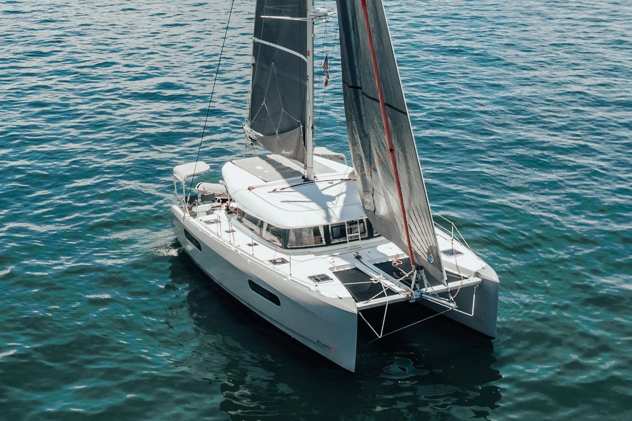 2020 Excess 12 catamaran sailing on calm waters.