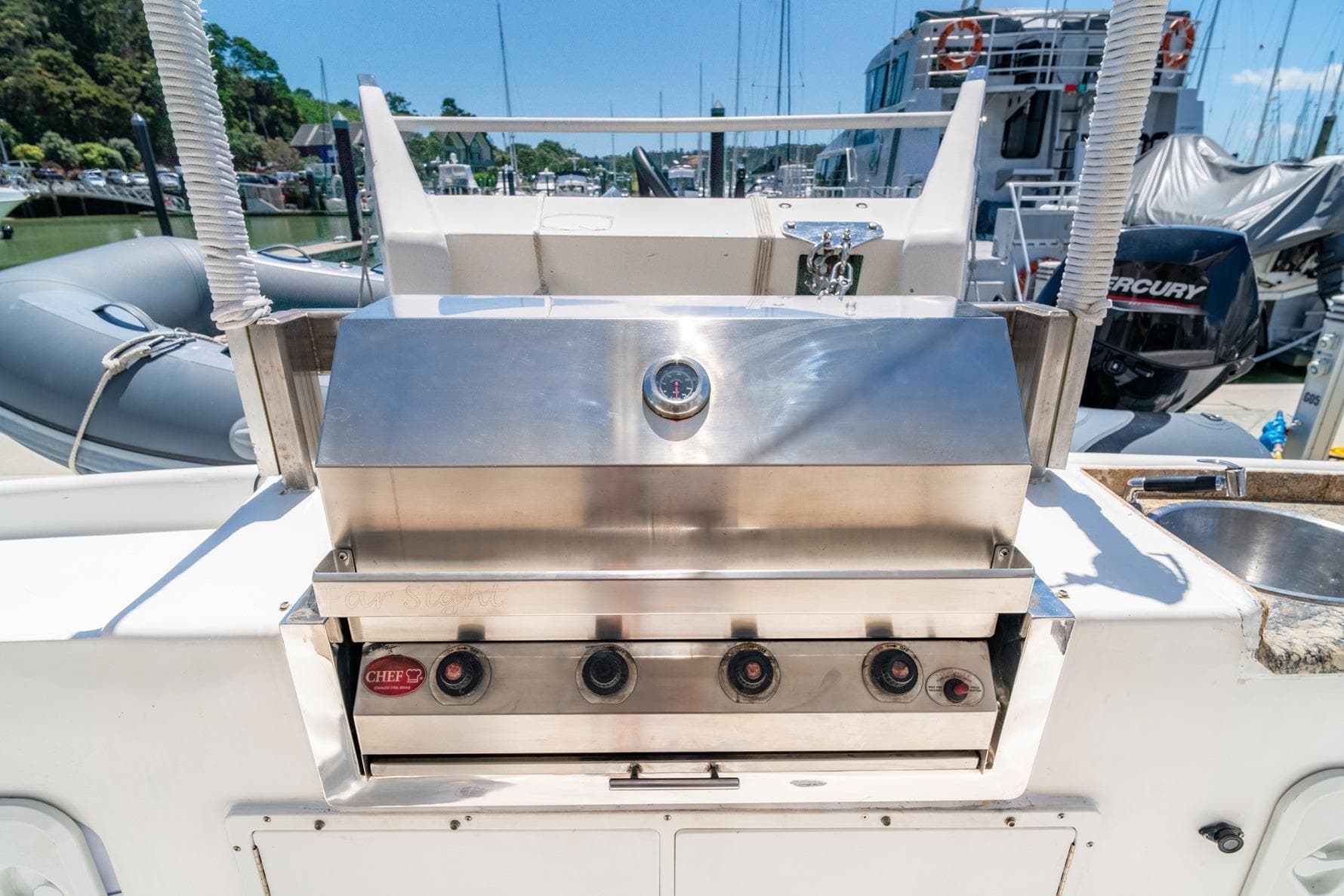 Outdoor grill on 2014 Royal Cape Majestic 530 yacht, docked at marina.